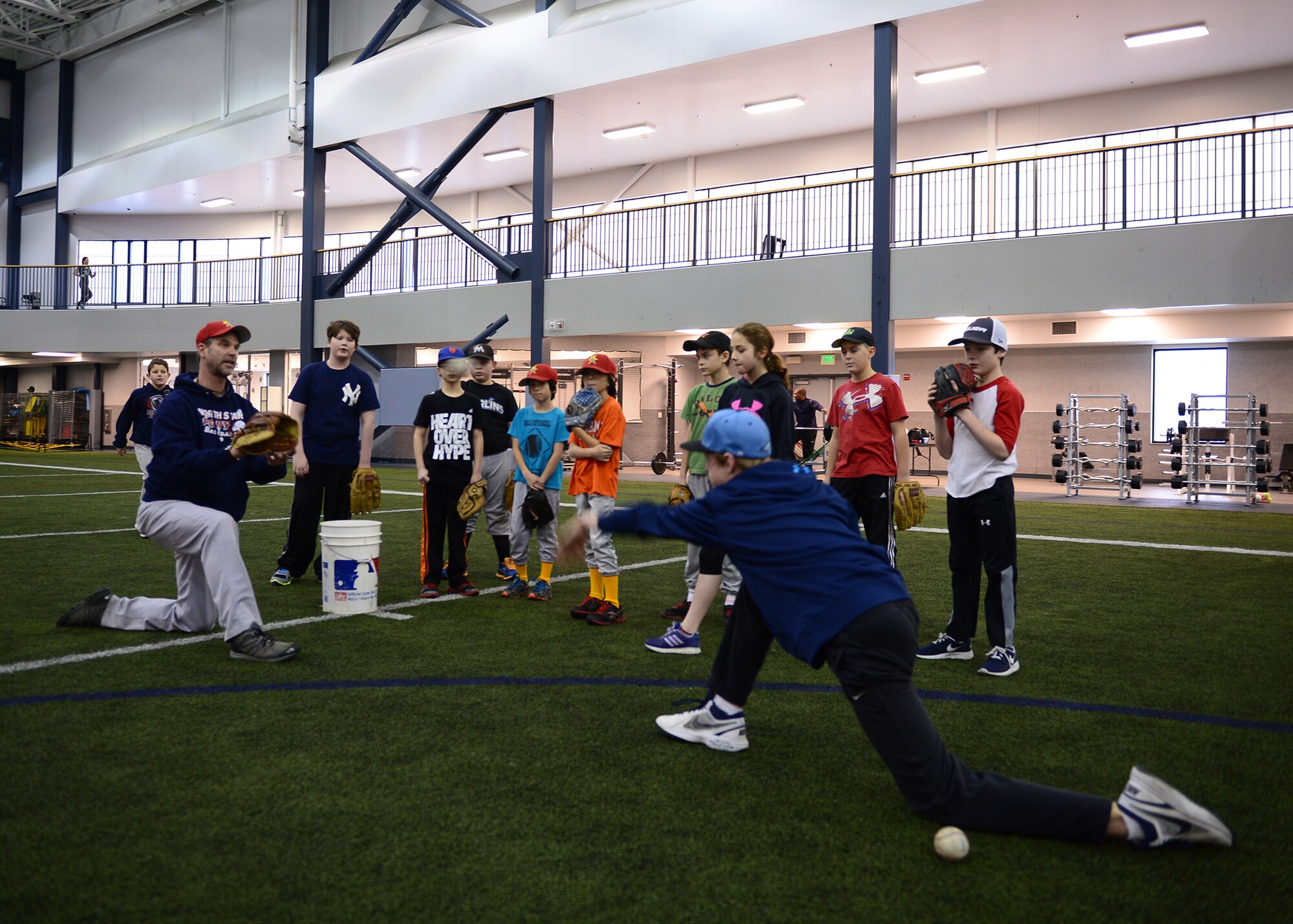 David Soderland, a coach for the Interior Baseball League, conducts a baseball clinic Oct. 14, 2015, in the Baker Field House at Eieslon Air Force Base, Alaska. With a new addition to the Community Partnership Initiative, nine- to 16-year-old youth will have year-round access to the sport by allowing children from off base to use the indoor facility while Eielson players will be provided reduced-cost league play in Fairbanks. (U.S. Air Force photo by Staff Sgt. Shawn Nickel/Released)