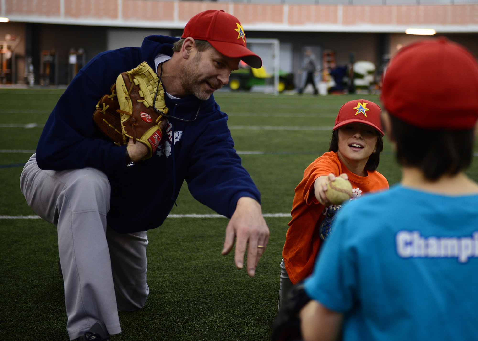 David Soderland, a coach for the Interior Baseball League, conducts a baseball clinic Oct. 14, 2015, in the Baker Field House at Eieslon Air Force Base, Alaska. With a new addition to the Community Partnership Initiative, nine- to 16-year-old youth will have year-round access to the sport by allowing children from off base to use the indoor facility while Eielson players will be provided reduced-cost league play in Fairbanks. (U.S. Air Force photo by Staff Sgt. Shawn Nickel/Released)