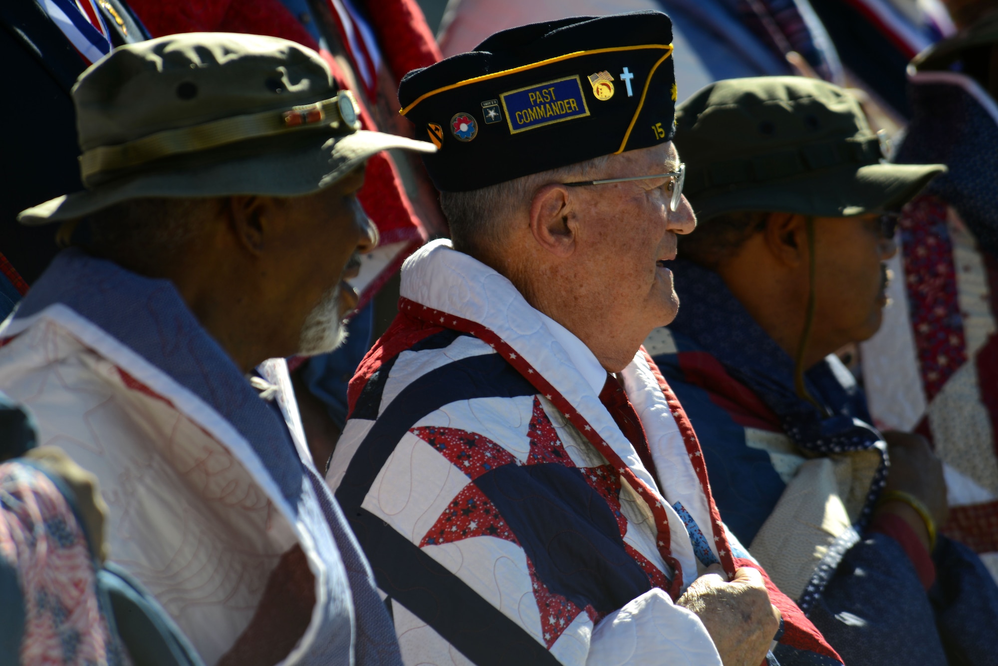 Veterans wear quilts given to them by Quilts of Valor during a Veterans Day ceremony held in Sumter, S.C., Nov. 11, 2015. Quilts of Valor, a national volunteer organization, has a mission to gift quilts to veterans who have been physically or psychologically wounded. (U.S. Air Force photo by Airman 1st Class Kelsey Tucker)