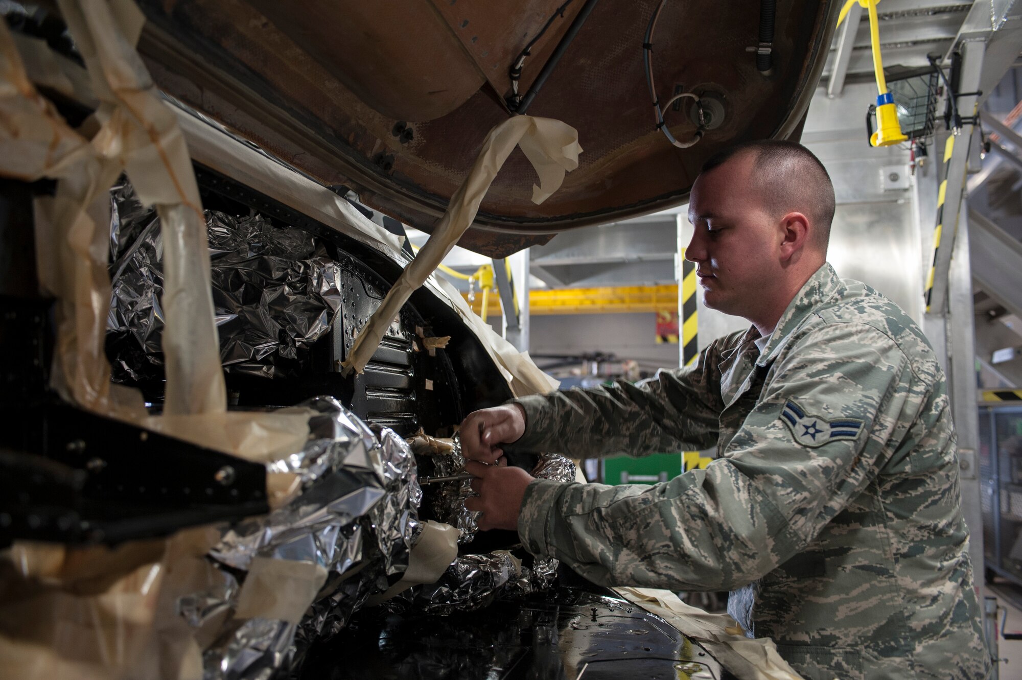 Airman 1st Class Trenton Faulkner, 823rd Maintenance Squadron crew chief, removes a screw inside the nose compartment of an HH-60G Pave Hawk at Nellis Air Force Base, Nev., Nov. 10, 2015. Faulkner and other 823rd MXS maintainers are responsible for maintaining the HH-60 fleet and ensuring they are mission ready for the 66th and 58th Rescue Squadrons to carry out their combat search and rescue operations. (U.S. Air Force photo by Staff Sgt. Siuta B. Ika)