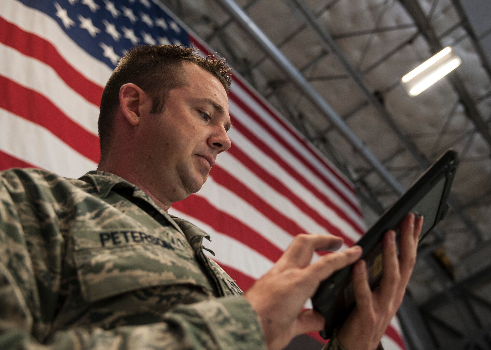 Staff Sgt. Brett Peterson, 823rd Maintenance Squadron engine troop, reviews a technical order at Nellis Air Force Base, Nev., Nov. 10, 2015. Technical orders provide Airmen all the information they need to accomplish a job safely and correctly. (U.S. Air Force photo by Staff Sgt. Siuta B. Ika)