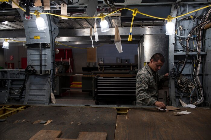 Senior Airman Zachry NacCarato, 823rd Maintenance Squadron crew chief, installs a cargo door stop mechanism on an HH-60G Pave Hawk at Nellis Air Force Base, Nev., Nov. 10, 2015. The 823d MXS’ mission is to deliver safe and reliable HH-60s along with effective Airmen to conduct personnel recovery missions that include combat search and rescue, as well as humanitarian relief operations in any environment worldwide. (U.S. Air Force photo by Staff Sgt. Siuta B. Ika)