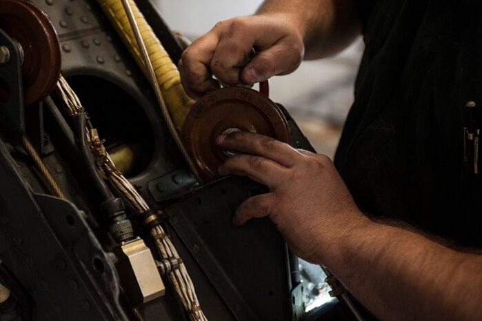Staff Sgt. Devon Boyda, 823rd Maintenance Squadron crew chief, installs a tail rotor cable pulley on an HH-60G Pave Hawk at Nellis Air Force Base, Nev., Nov. 10, 2015. The 823rd MXS houses approximately 18 Pave Hawks and almost 400 Airmen, providing logistical support for the U.S. Air Force Weapons School and Detachment 1 of the 18th Flight Test Squadron. (U.S. Air Force photo by Staff Sgt. Siuta B. Ika)