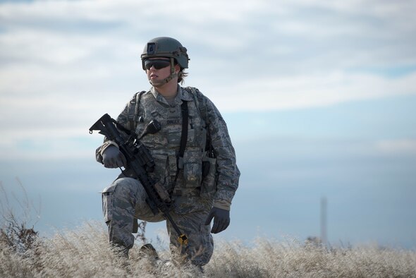Airman 1st Class Alexis Dinger, 366th Security Forces Squadron response force leader, kneels while patrolling an area during Gunfighter Flag 16-1 Nov. 5, 2015, at Mountain Home Air Force Base, Idaho. The goal of the patrol was to gather Intelligence on the simulated enemy. (U.S. Air Force photo by Airman Chester Mientkiewicz/RELEASED)