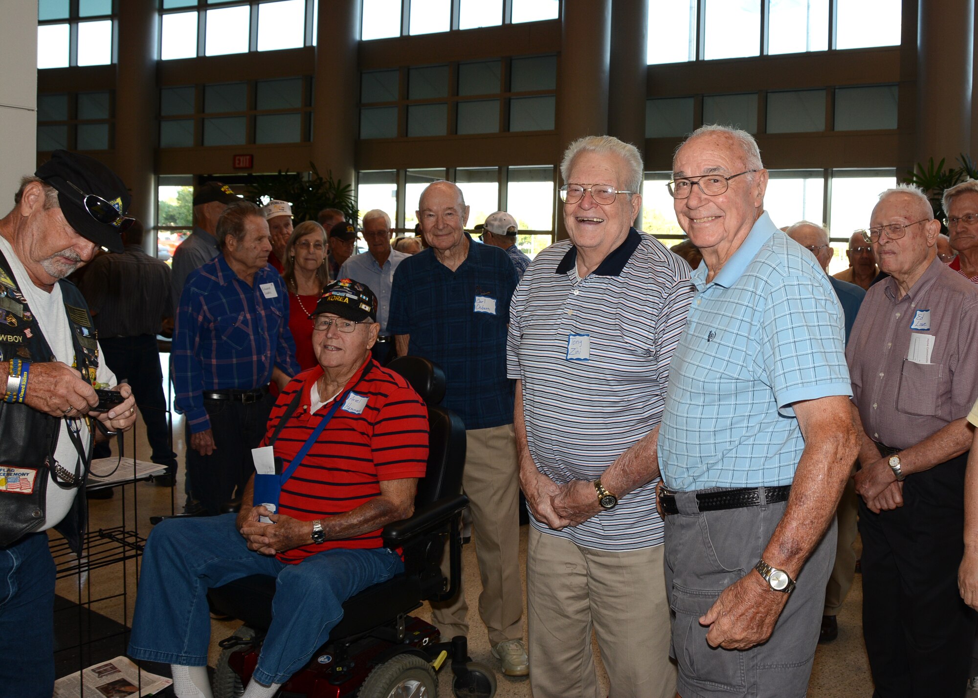 Oklahoma Veterans from WWII and the Korean War gather in the lobby of the Hudiburg Center prior the start of the Honor Flight reception ceremony Sept. 15, 2015, in Midwest City, Okla. Eighty-one Oklahoma veterans flew to Washington, D.C. the following day to visit memorials built in their honor as part of the Oklahoma Honor Flight Program. (U.S. Air Force photo by Tech. Sgt. Lauren Gleason)

