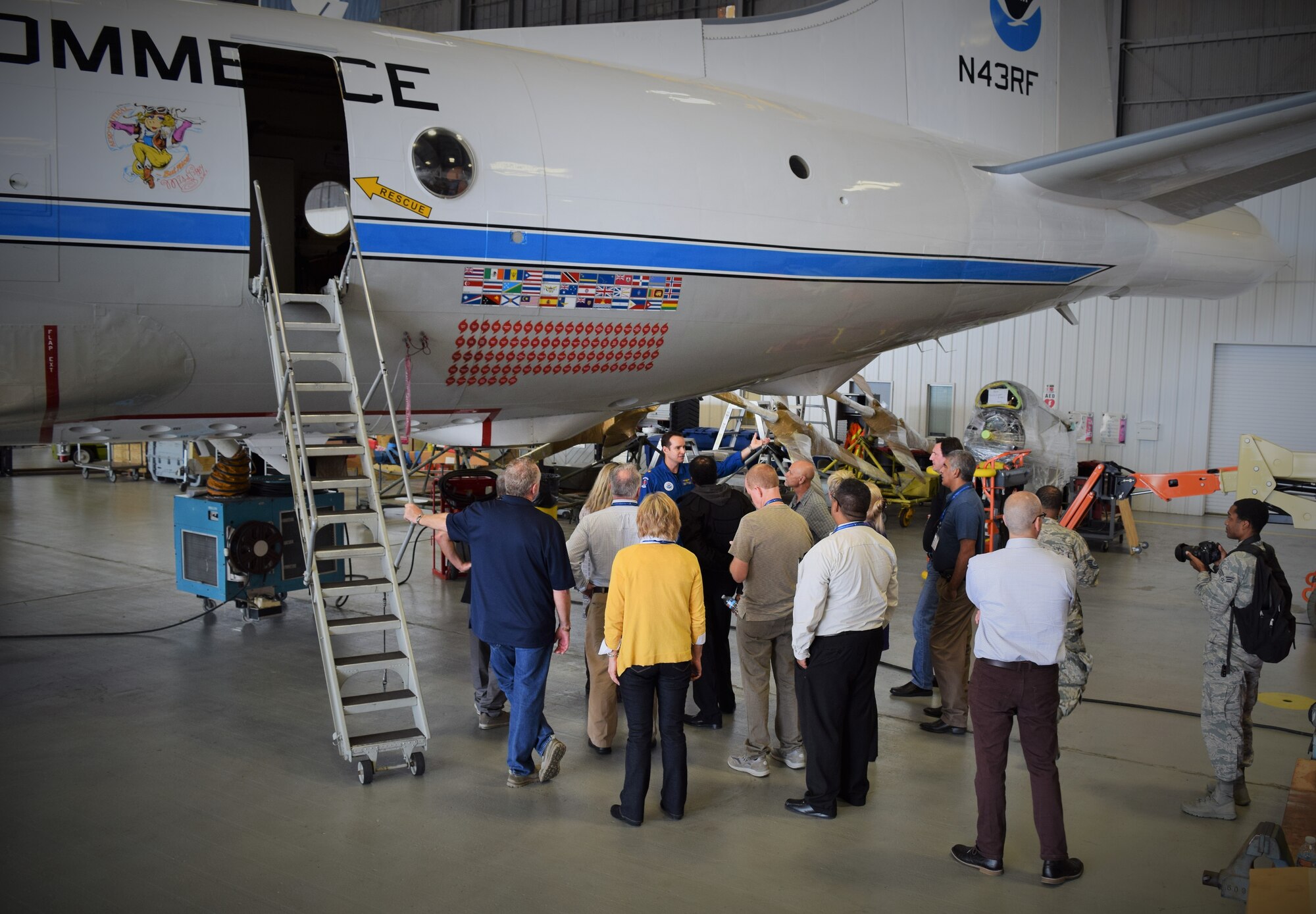 Lt. Cmdr. Douglas MacIntyre, National Oceanic and Atmospheric Administration aircraft commander, discusses the decals on the side of a WP-3D Orion with San Antonio employers during a tour of the NOAA Nov. 13, 2015 at MacDill Air Force Base, Florida. The tour was part of the 433rd Airlift Wing’s two-day 2015 Employer Support of the Guard and Reserve Boss Lift. (U.S. Air Force photo/Tech. Sgt. Lindsey Maurice)