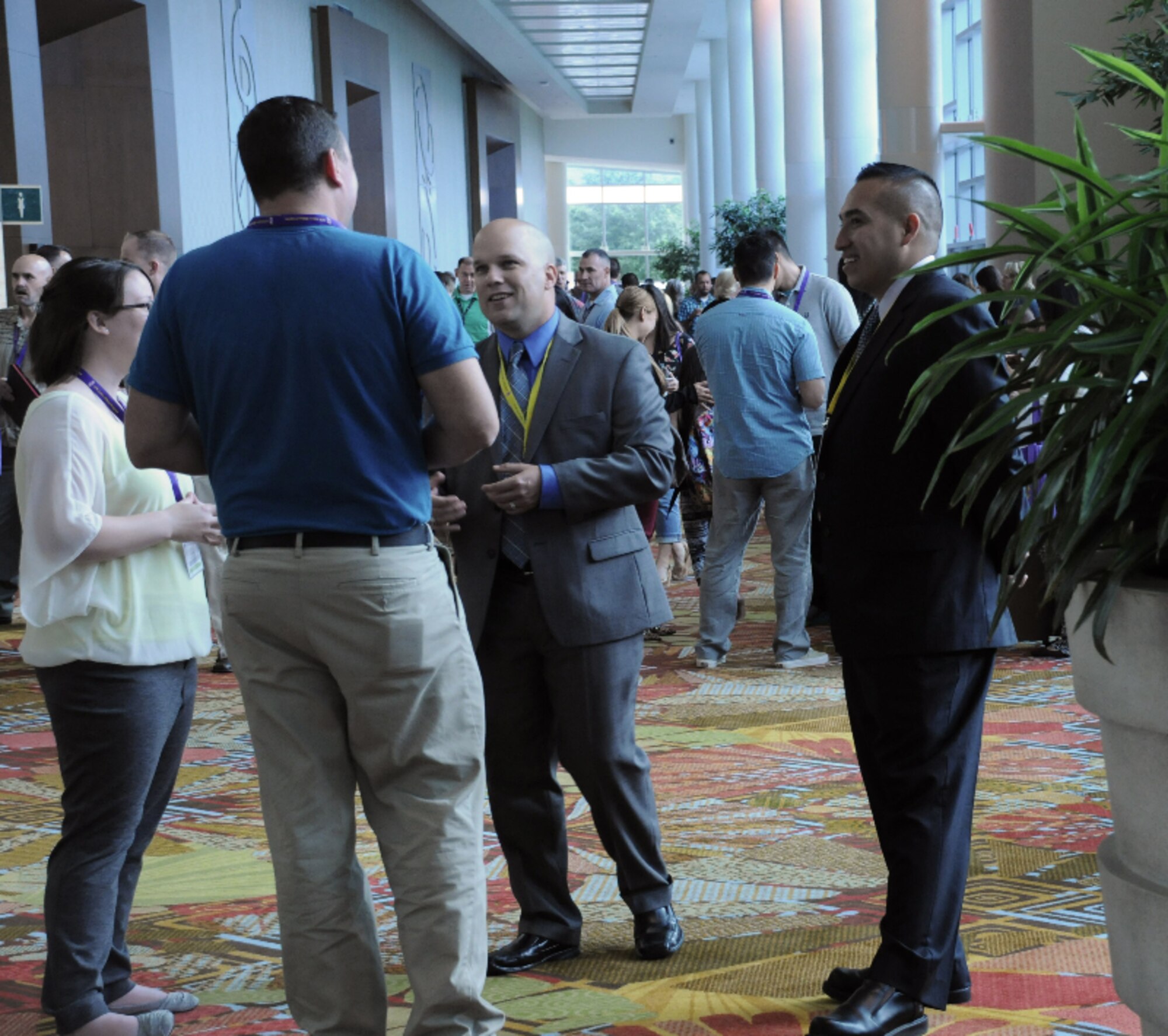 Tech. Sgts. Hector Flores and Ron DeBusk, both from the 507th Security Forces Squadron at Tinker Air Force Base, Oklahoma, talk to Air Force Reserve Yellow Ribbon Reintegration Program participants Sept. 27, 2015, in Orlando, Florida. They were part of an eight-person security detail responsible for 900 participants at the event, which promotes the well-being of reservists and their families by connecting them with resources before and after deployments. (U.S. Air Force photo by Staff Sgt. Matthew Burke) 
