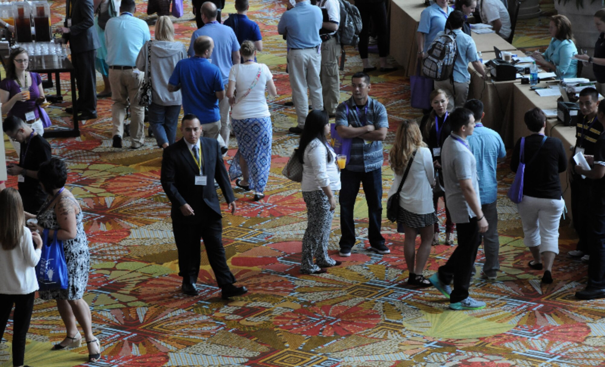 Security detail member Tech. Sgt. Hector Flores walks the main corridor at an Air Force Reserve Yellow Ribbon Reintegration Program event Sept. 27, 2015, in Orlando, Florida. Flores, a member of the 507th Security Forces Squadron at Tinker Air Force Base, Oklahoma, was part of an eight-person security detail responsible for 900 participants at the event. Yellow Ribbon promotes the well-being of reservists and their families by connecting them with resources before and after deployments. (U.S. Air Force photo by Staff Sgt. Matthew Burke)