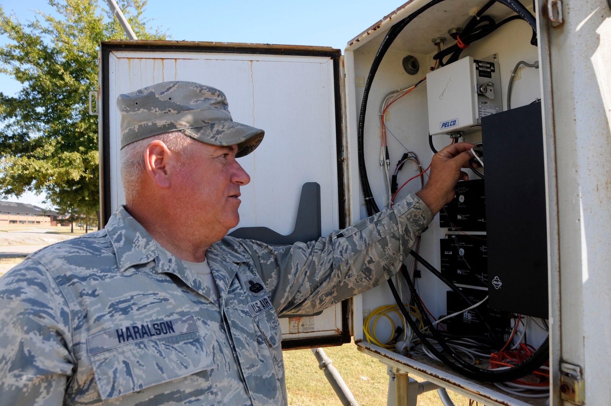 Master Sgt. Jodie Haralson, 188th Communications Flight noncommissioned officer in charge of infrastructure, conducts an operations check on fiber optic cables at Ebbing Air National Guard Base, Ark., Oct 14, 2015. Haralson brings diverse experience and knowledge to the 188th Wing and Arkansas Air National Guard as he served as a prior Marine and currently volunteers on the U.S. Coast Guard Auxiliary as the vice commander of Flotilla 15-5, Fort Smith. (U.S. Air National Guard photo by Staff Sgt. Han nah Dickerson/Released)