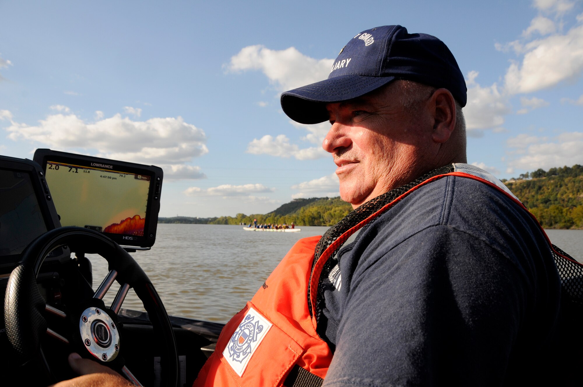Jodie Haralson, U.S. Coast Guard Auxiliary volunteer, patrols the Arkansas River as a team practices a run on a dragon boat, Oct. 6, 2015, Fort Smith Ark. Haralson is vice commander of Flotilla 15-5, Fort Smith, and is a master sergeant assigned to the 188th Communications Flight where he serves as the noncommissioned officer in charge of infrastructure. Haralson brings diverse experience and knowledge to the 188th Wing and Arkansas Air National Guard as he also previously served as a Marine. (U.S. Air National Guard photo by Staff Sgt. Hannah Dickerson/Released)