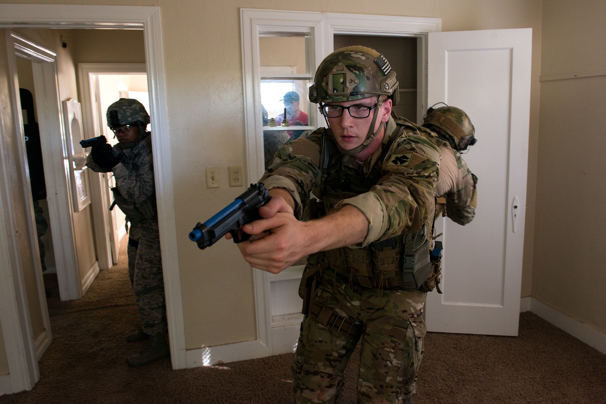 Airmen from Will Rogers Air National Guard Base in Oklahoma City move as a team to search and clear a structure at Southern Nazarene University  in Bethany, Okla., during a Special Weapons and Tactics school held by the Oklahoma County Sheriff’s Office, Oct. 26 to Nov. 6, 2015. (U.S. Air National Guard photo by Master Sgt. Andrew M. LaMoreaux)