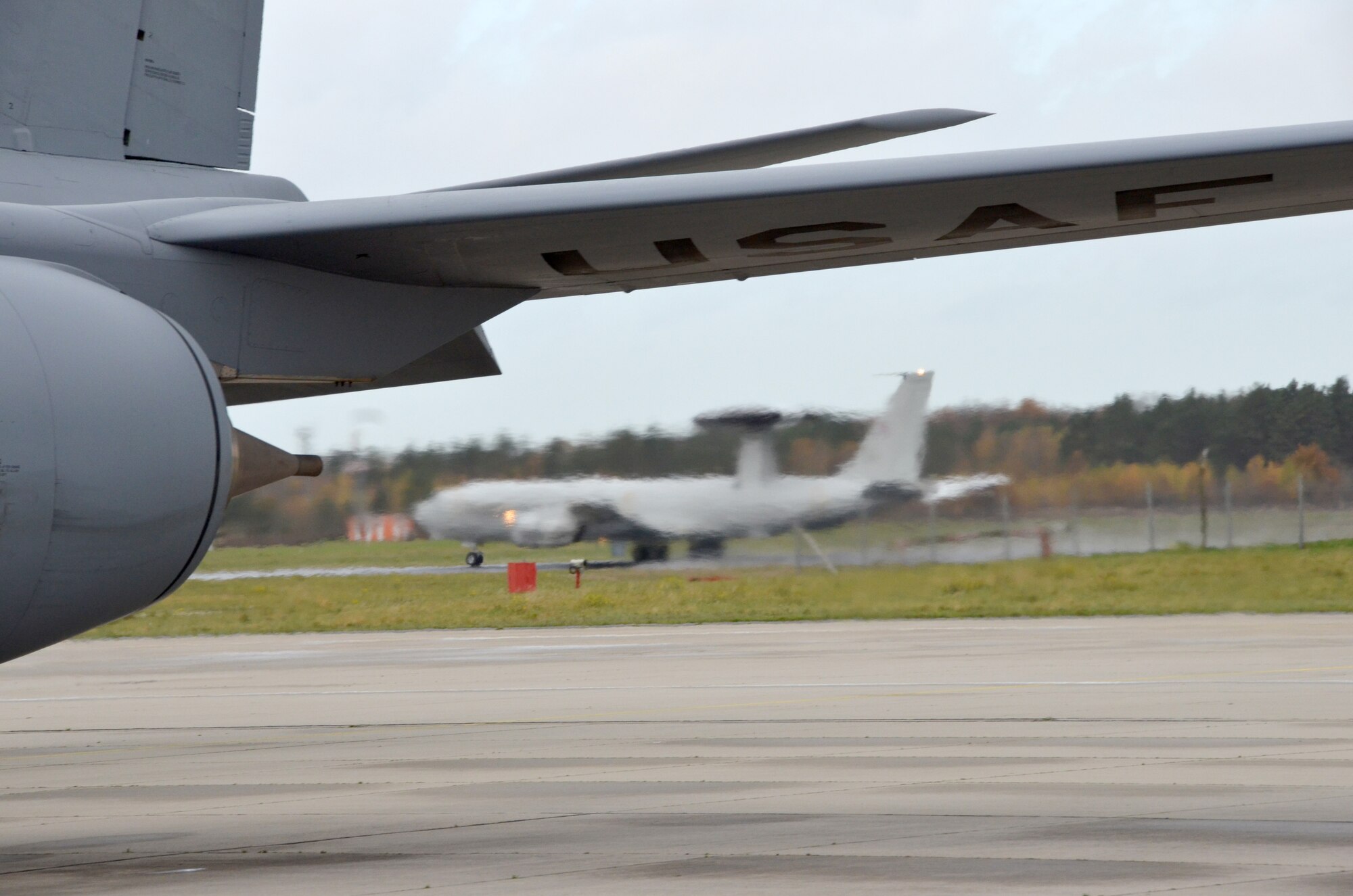 A NATO E-3A Sentry takes off from NATO Air Base Geilenkirchen, Germany, Nov. 13 while an Arizona Air National Guard KC-135 Stratotanker  prepares for launch. Both aircraft rendezvoused over northern Germany during a training mission to practice air refueling. Airmen from the 161st Air Refueling Wing based in Phoenix are supporting aircrew training operations here Nov. 9-20. (U.S. Air National Guard photo by Lt. Col. Gabe Johnson)