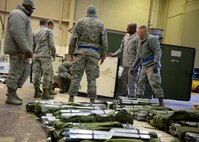 Members of Team McConnell count out and line up cots during Global Thunder Nov. 2 - 8 Fairchild Air Force Base, Wash. The 22nd ARW teamed up with the 92nd ARW and used their day to day mission capabilities of air refueling to enable USSSTRATCOM to conduct global combat and reconnaissance operations. (U.S. Air Force photo by 2nd Lt Krystal Jimenez)