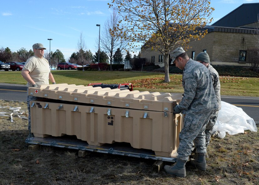 Staff Sgt. Joseph Stroud, 22nd MDSS community health noncommissioned officer in charge and, Capt. Michael Marx, 22nd Aerospace Medical Squadron Flight Medicine physician assistant practice setting up a medical tent as part of Global Thunder 16, November 2 - 8, 2015, Fairchild Air Force Base, Wash. Global Thunder provided training opportunities for units to showcase mobility readiness. (U.S. Air Force photo by 2nd Lt Krystal Jimenez)
