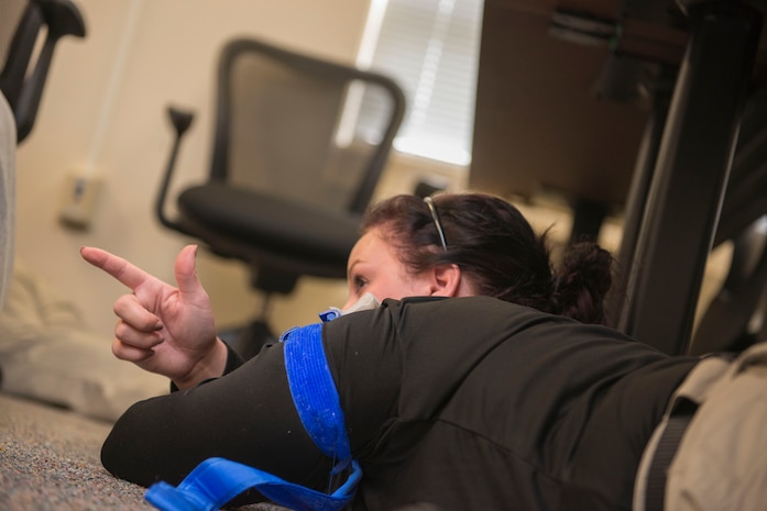 Law enforcement officers are practicing how to apply a tourniquet, take cover and still try and have their weapon trained on their target during an active shooter exercise at the Federal Law Enforcement Training Center in Charleston, S.C., on Nov. 6, 2015. The active shooter training program is a four day course to help law enforcement officers better handle an actual active shooter situation. (U.S. Air Force photo/Airman 1st Class Thomas T. Charlton)