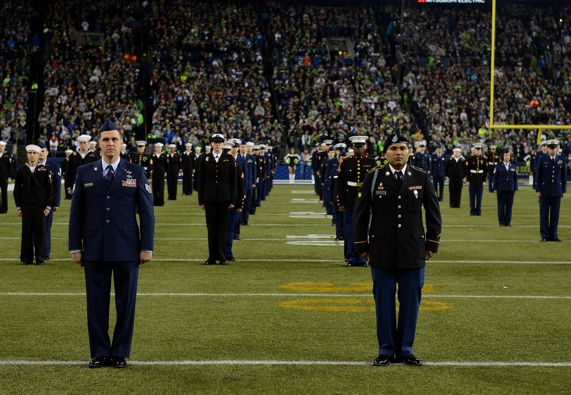 Service members from the Air Force, Army, Coast Guard, Marines, and Navy, stand at attention during the pregame “Salute to Service” ceremony at Century Link field Nov. 15, 2015, in Seattle, Wash. More than 200 military members participated in the Seattle Seahawks “Salute to Service” pregame and halftime ceremonies. (U.S. Air Force photo/Senior Airman Divine Cox)