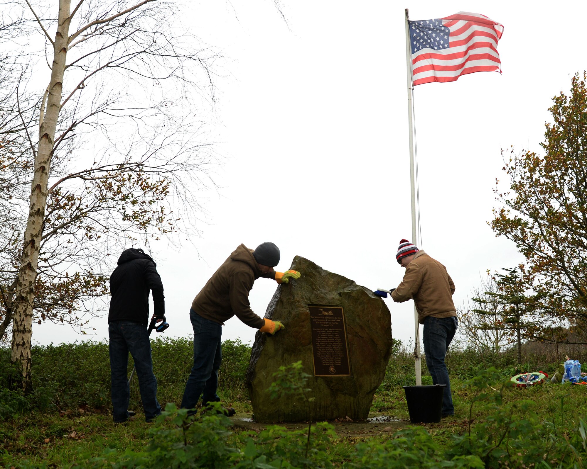 U.S. Air Force Airmen from RAF Mildenhall clean the Thorney Dyke memorial Nov. 14, 2015, near Peterborough, England.  On Aug. 28, 1976, a U.S. Air Force C-141A Starlifter assigned to the 438th Military Airlift Wing at McGuire Air Force Base, New Jersey, crashed during a thunderstorm on approach to RAF Mildenhall. The memorial site commemorates the Airmen who lost their lives on that day. (U.S. Air Force photo by Airman 1st Class Justine Rho/Released)