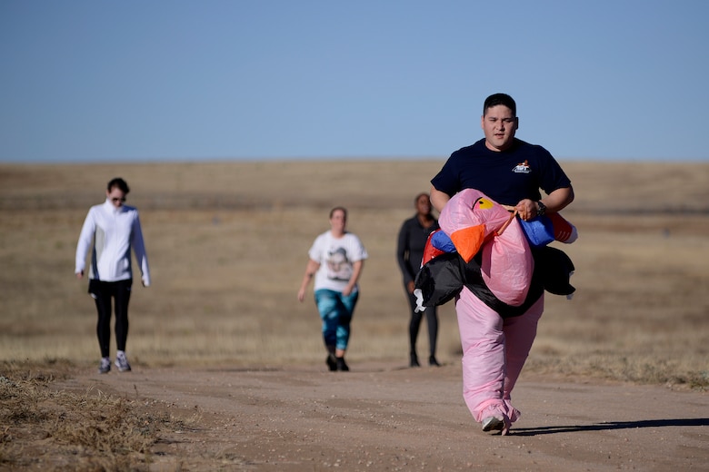 Master Sgt. Steven Grant, 50th Contracting Squadron, completes the 15th annual Turkey Trot, while in full turkey costume, Tuesday, Nov. 10, 2015, at Schriever Air Force Base, Colorado.  The Turkey Trot was held in conjunction with the monthly Warfit Run with participants able to run in civilian clothes if they brought a donation of canned goods. (U.S. Air Force photo/Christopher DeWitt)