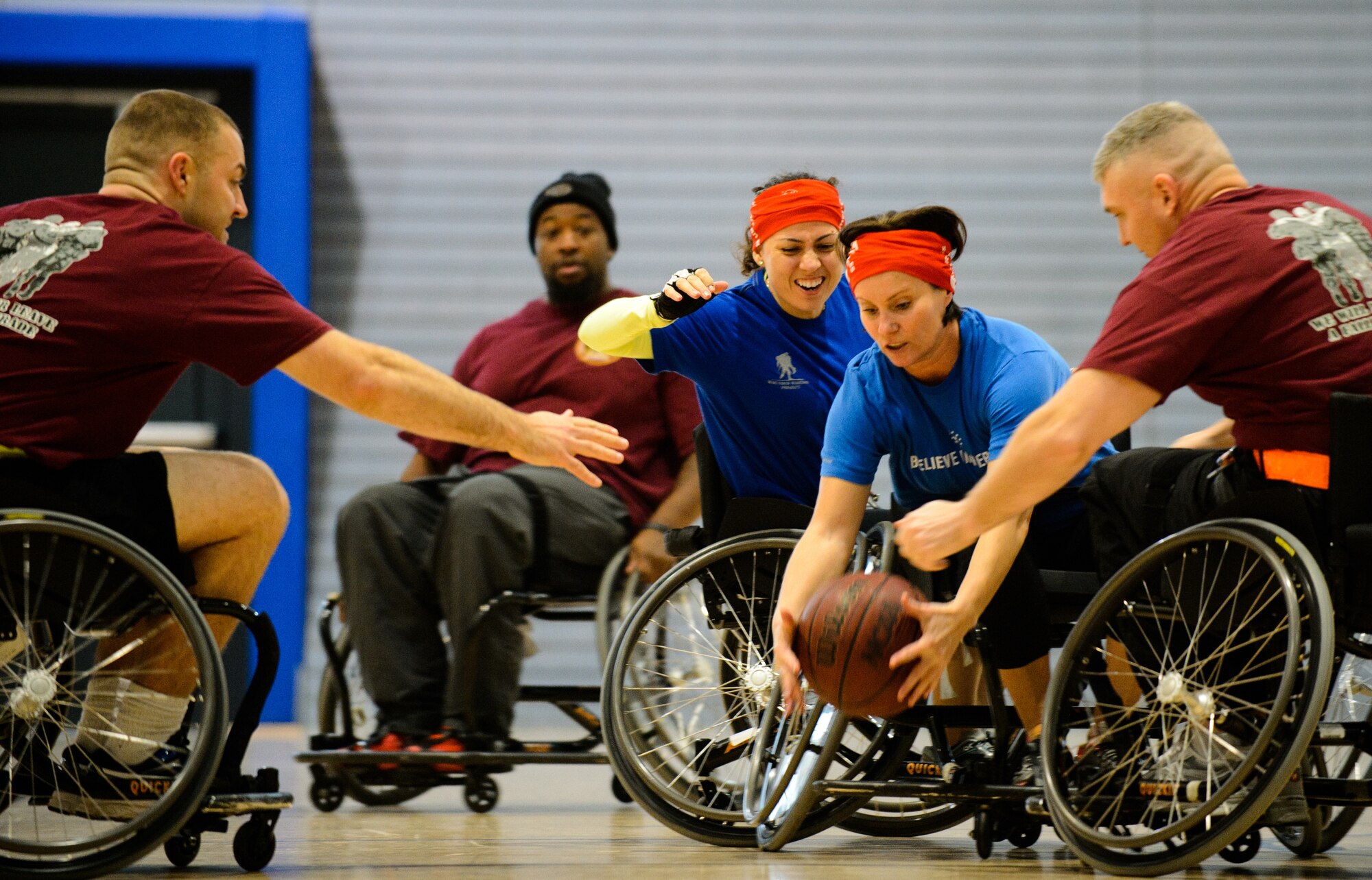 Members of the American Red Cross and Headquarters Wounded Transition Unit teams go for a ball during a tournament Nov. 13, 2015, at Ramstein Air Base, Germany. Airmen and Soldiers learned how wheelchair basketball levels the playing field and encourages competition and camaraderie. (U.S. Air Force photo/Staff Sgt. Armando A. Schwier-Morales)