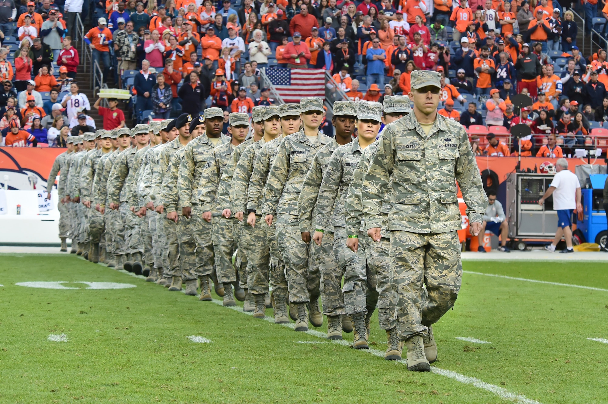 U.S. Air Force members march onto the field Nov. 15, 2015, at Sports Authority Field at Mile High Stadium, Denver. The Denver Broncos held their Salute to Service game on Sunday against the Kansas City Chiefs and honored military members before the game and during halftime. (U.S. Air Force photo by Airman 1st Class Luke W. Nowakowski/Released)