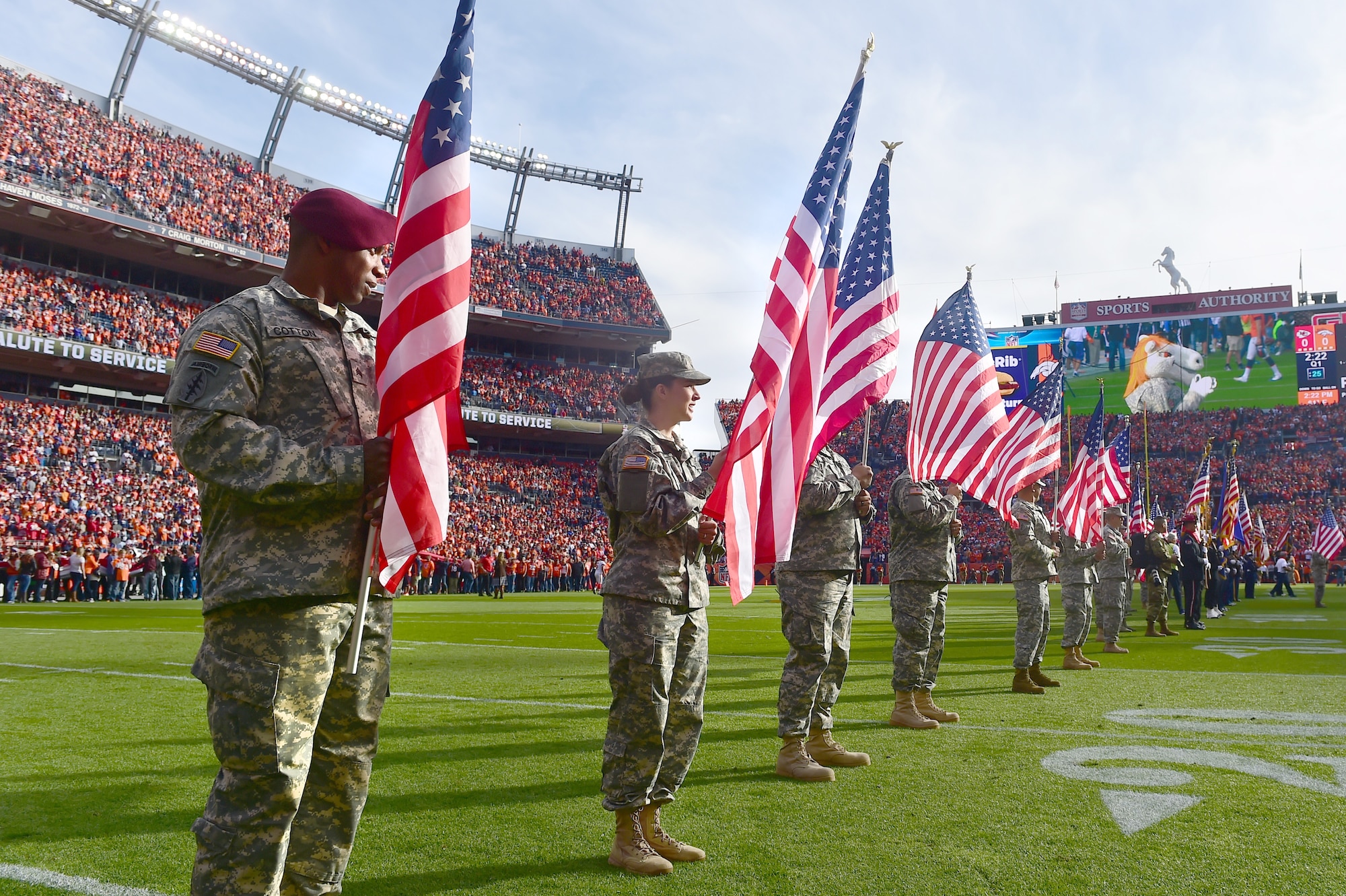 Military members hold up American flags before the Denver Broncos game Nov. 15, 2015, at Sports Authority Field at Mile High Stadium, Denver. The Broncos hosted military members at their Salute to Service game against the Kansas City Chiefs. (U.S. Air Force photo by Airman 1st Class Luke W. Nowakowski/Released) 