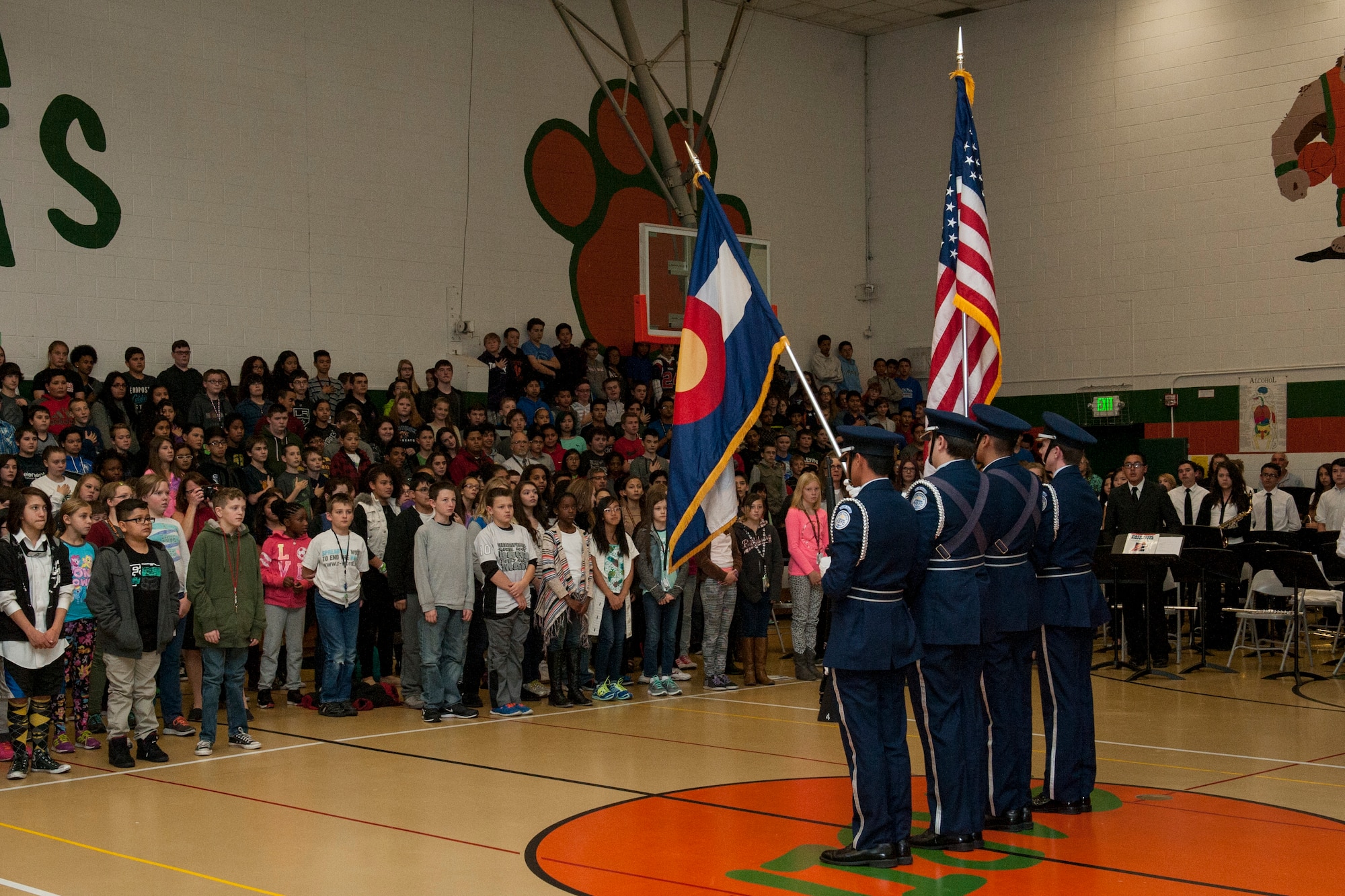 COLORADO SPRINGS, Colo. – Mitchell Air Force Junior ROTC presents the colors at the beginning of the Sabin Middle School Veterans Day program Nov. 11, 2015. Students from the Vossler NCO Academy were guest speakers for different classes throughout the day to talk about their careers in the Air Force and discuss with the middle school students what Veterans Day means to them. (U.S. Air Force photo by Senior Airman Rose Gudex)