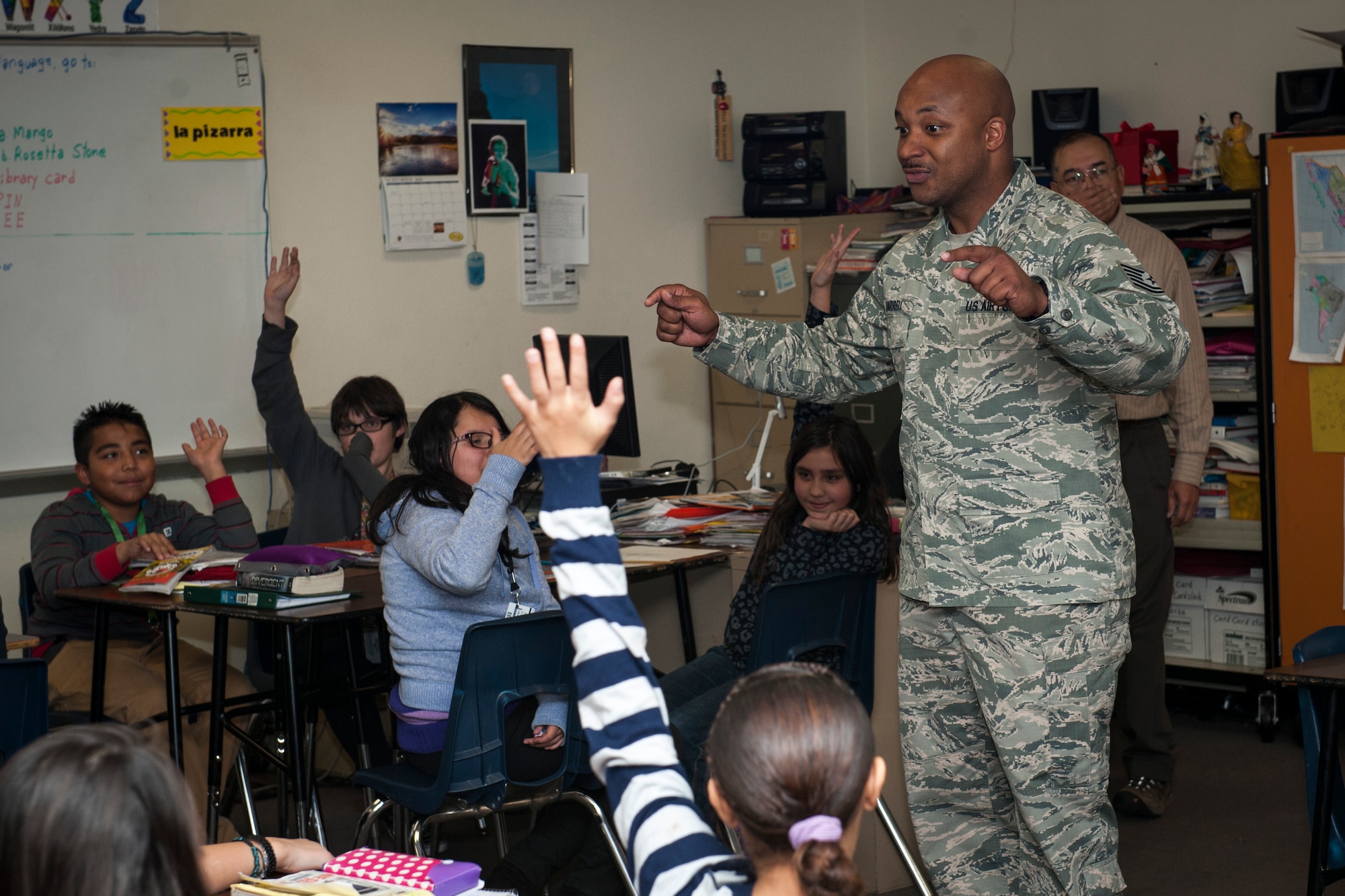 COLORADO SPRINGS, Colo. – Tech. Sgt. Dwayne Harrell, 92nd Communications Squadron at Fairchild Air Force Base, Wash., and Sabin Middle School students talk about Veterans Day and what it means to them Nov. 11, 2015. Harrell is attending the Vossler NCO Academy at Peterson AFB and went to the school with other VNCOA students to honor military veterans who came before them. (U.S. Air Force photo by Senior Airman Rose Gudex)