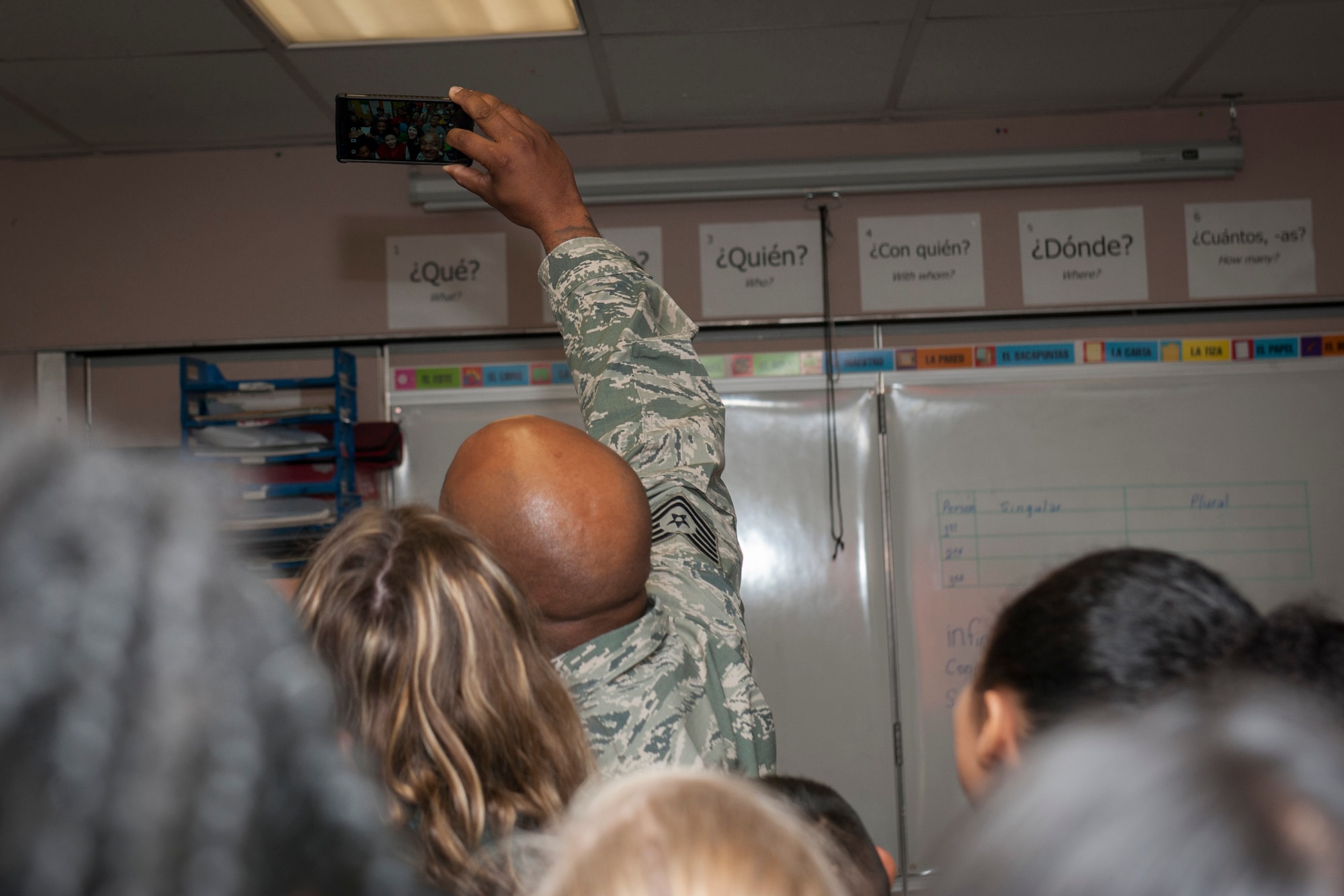 COLORADO SPRINGS, Colo. – Tech. Sgt. Dwayne Harrell, from the 92nd Communications Squadron at Fairchild Air Force Base, Wash., takes an “selfie” with a seventh grade world language class at Sabin Middle School, Nov. 11, 2015. Harrell is at Peterson AFB to attend Vossler NCO Academy and spent Veterans Day talking with students about what it means to be a service member and serve in the Air Force. (U.S. Air Force photo by Senior Airman Rose Gudex)
