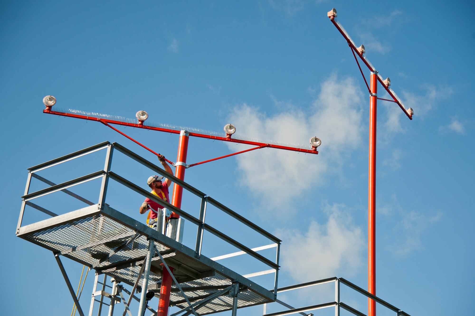 Dusty Dees, 796th Civil Engineer Squadron, uses a crank system to lower an airfield approach lighting spire to change out a lamp Oct. 29 at Eglin Air Force Base, Fla.  These elevated systems at Eglin and Duke Field are maintained by the 796th CES.  Eglin and Duke’s systems contain 60 elevated towers.   Each contains four 200-watt lamps.  Civil Engineer personnel change out approximately 60 of the 240 lamps used at the top of the spires every year.  (U.S. Air Force photo/Samuel King Jr.)