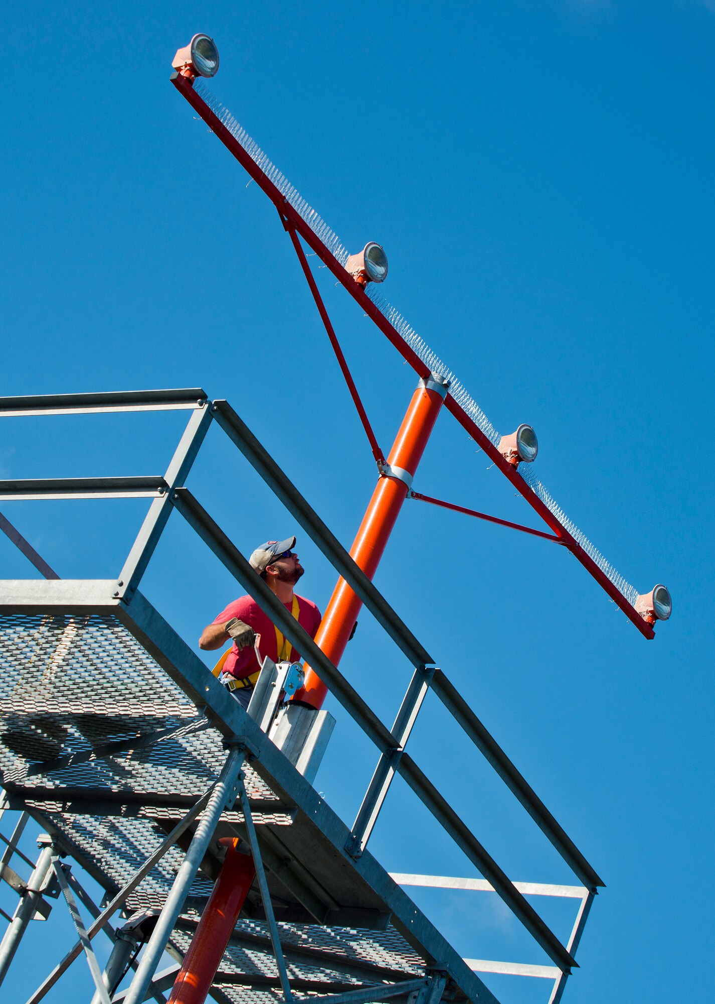 Dusty Dees, 796th Civil Engineer Squadron, uses a crank system to lower an airfield approach lighting spire to change out a lamp Oct. 29 at Eglin Air Force Base, Fla.  These elevated systems at Eglin and Duke Field are maintained by the 796th CES.  Eglin and Duke’s systems contain 60 elevated towers.   Each contains four 200-watt lamps.  Civil Engineer personnel change out approximately 60 of the 240 lamps used at the top of the spires every year.  (U.S. Air Force photo/Samuel King Jr.)