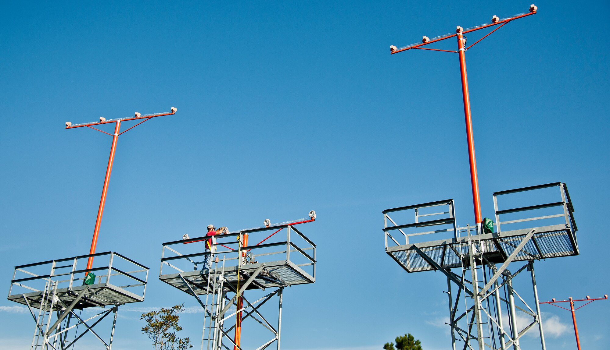 Dusty Dees, 796th Civil Engineer Squadron, changes out a bulb on one of the airfield approach lighting system towers Oct. 29 at Eglin Air Force Base, Fla.  These elevated systems at Eglin and Duke Field are maintained by the 796th CES.  Eglin and Duke’s systems contain 60 elevated towers.   Each contains four 200-watt lamps.  Civil Engineer personnel change out approximately 60 of the 240 lamps used at the top of the spires every year.  (U.S. Air Force photo/Samuel King Jr.)