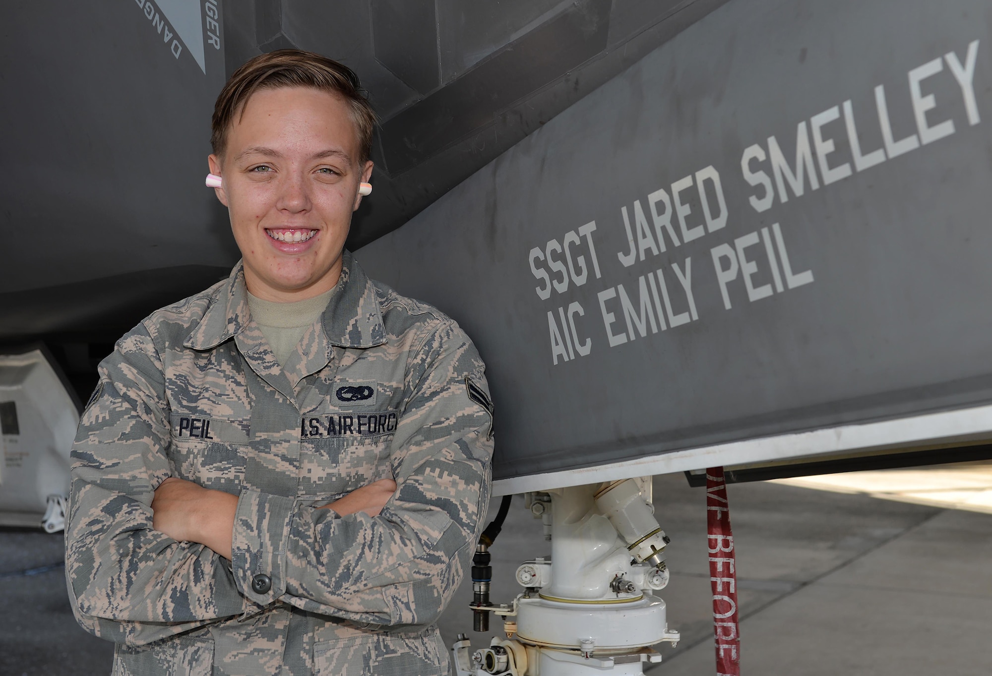 Airman 1st Class Emily Peil, 33rd Aircraft Maintenance Squadron crew chief, stands with the jet that bears her name at Eglin Air Force Base, Fla., Oct. 8. Peil is one of the first crew chiefs to begin her career on the fifth generation F-35A Lightning II straight from technical school. (U.S. Air Force Photo/Senior Airman Andrea Posey)
