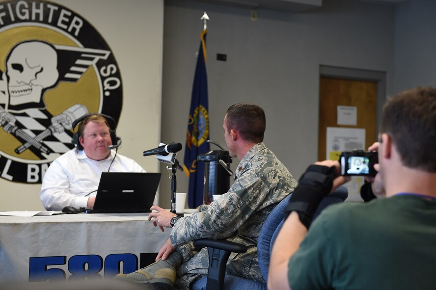 Kevin Miller of KIDO radio in Boise, interviews Major Chris Borders, Idaho National Guard public affairs officer, during the broadcast of his morning talk show on Nov. 10, 2015 from the 124th Fighter Wing, Boise, Idaho. Miller spoke with six members of the Idaho Air National Guard about their experiences in the National Guard, work and life balance, and the greater mission and future of the 124th Fighter Wing.   (Air National Guard photo by Tech. Sgt. Sarah Pokorney/Released)