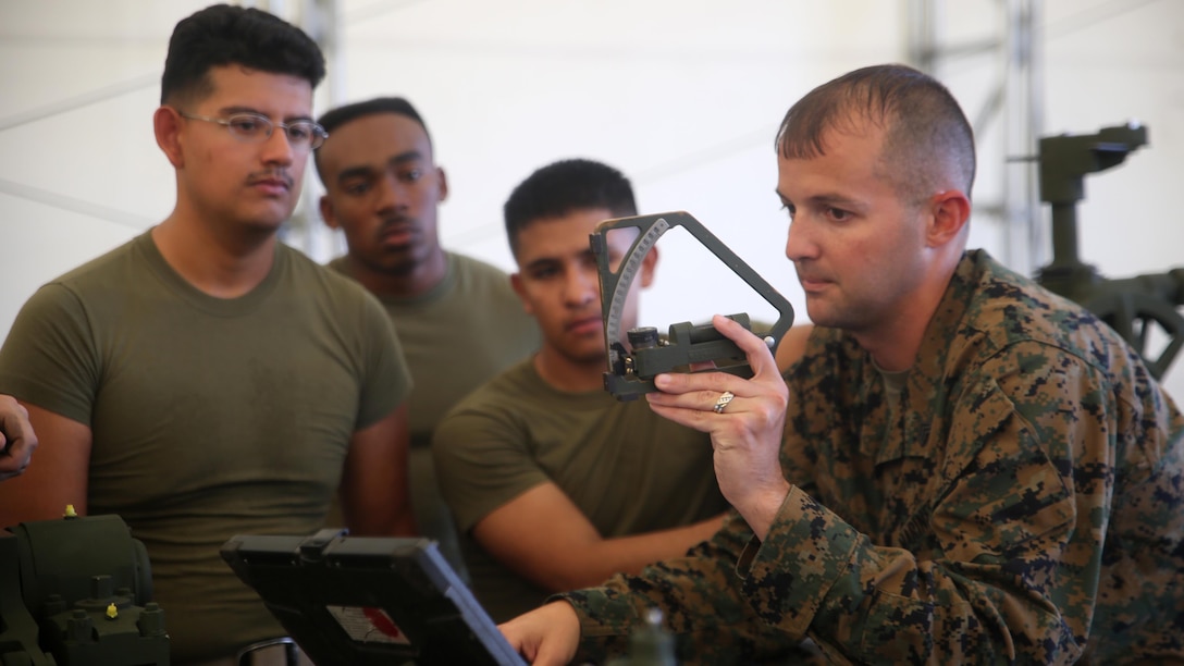 Sergeant James Norman, an instructor 10th Marine Regiment’s Artillery Assistant Gunners and Gunners Course, teaches the functions of a gunner’s quadrant Nov. 6, 2015, at Marine Corps Base Camp Lejeune, N.C. The month-long course trains Marines to transition from basic field artillery cannoneers to assistant gunners and gunners within their gun sections. 