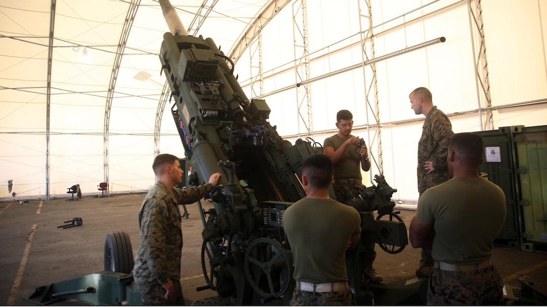 Marines with 10th Marine Regiment team up for a practical application session on a M777A2 Howitzer during the Artillery Assistant Gunners and Gunners Course Nov. 6, 2015, at Marine Corps Base Camp Lejeune, N.C. The month-long course trains Marines to transition from basic field artillery cannoneers to assistant gunners and gunners within their gun sections. 