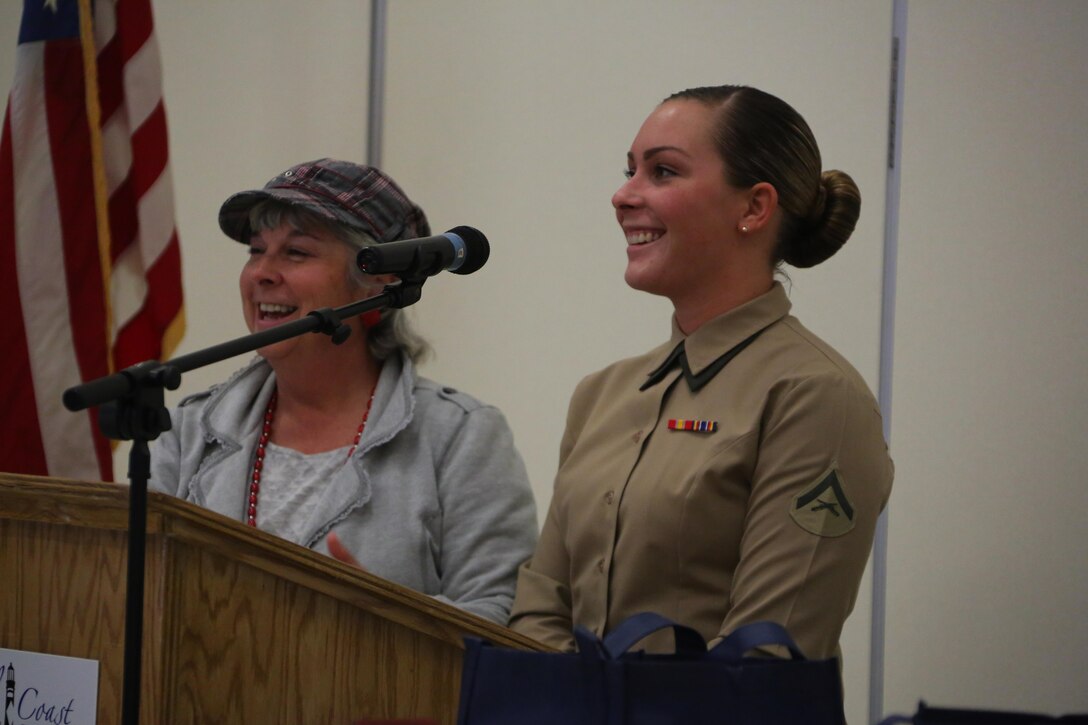 Darleen Jones, and Lance. Cpl. Allison App speak to an audience during the Carteret County Chamber of Commerce Service Person of the Quarter ceremony in Morehead City, N.C., Nov. 13, 2015. App was recognized as the Marine Corps Air Station Cherry Point Service Person of the Quarter for her dedication to both her career as a Marine and her service to the community. App has completed more than 300 volunteer hours with numerous organizations while maintaining an exemplorary role as a Marine amongst her peers. Jones is a liaison specialist with the air station and App is an administrative specialist with Marine Wing Headquarters Squadron 2 at Marine Corps Air Station Cherry Point, N.C.(U.S. Marine Corps photo by Cpl. N.W. Huertas/ Released)