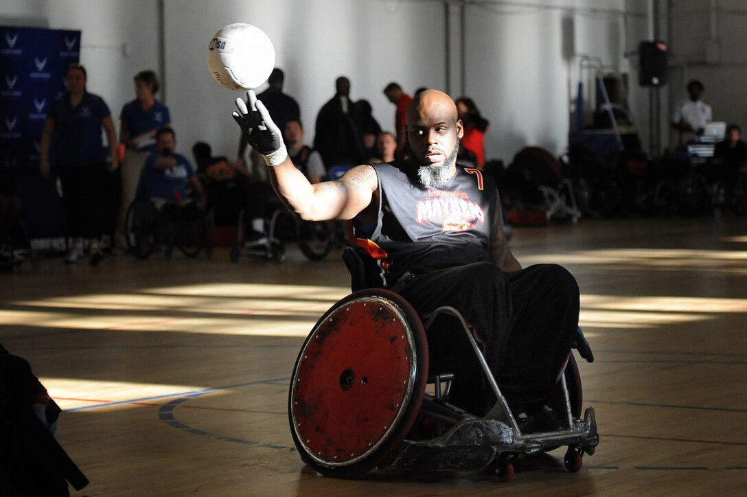 Louis Fortune, a member of the Maryland Mayhem Quad Rugby team, demonstrates ball control as his team goes up against the Capital Punishers during an exhibition match at the Joint Services Wheelchair Rugby Exhibition during Warrior Care Month 2015 on Joint Base Andrews, Md., Nov. 16, 2015. DoD photo by Marvin Lynchard
