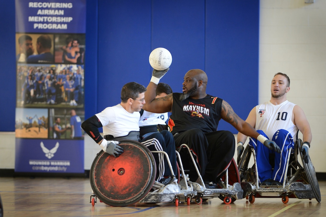 Louis Fortune, a member of the Maryland Mayhem Quad Rugby team, demonstrates ball control as his team battles the Capital Punishers during an exhibition match at the Joint Services Wheelchair Rugby Exhibition during Warrior Care Month 2015 on Joint Base Andrews, Md., Nov. 16, 2015. DoD photo by Marvin Lynchard