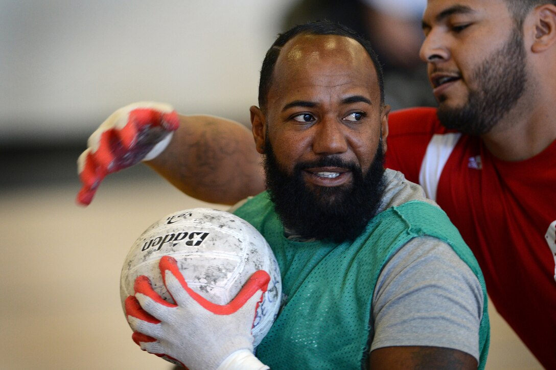 Wounded Warriors from all branches of the Armed Forces hone their rugby skills by protecting the ball as they participate in All Service Rugby Training during Warrior Care Month 2015 Joint Services Wheelchair Rugby Exhibition on Joint Base Andrews, Md., Nov. 16, 2015.DoD photo by Marvin Lynchard