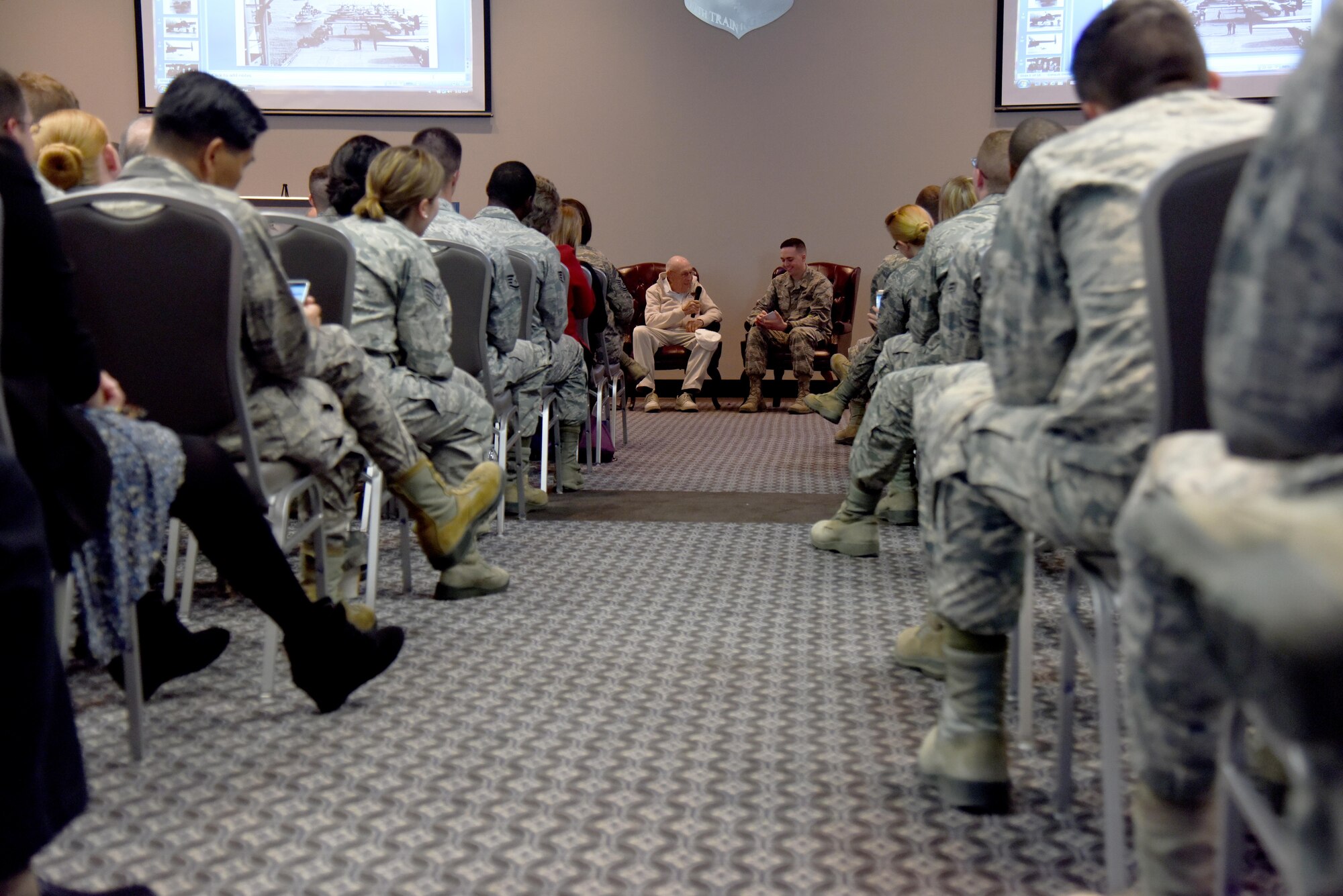 Retired U.S. Army Air Corps Lt. Col. Richard E. Cole, Doolittle Raider, speaks to the crowd during Q-and-A session at the Event Center on Goodfellow Air Force Base, Texas, Nov. 12, 2015. After the Q-and-A session Cole posed for photos and signed autographs. (U.S. Air Force photo by Senior Airman Joshua Edwards/Released)