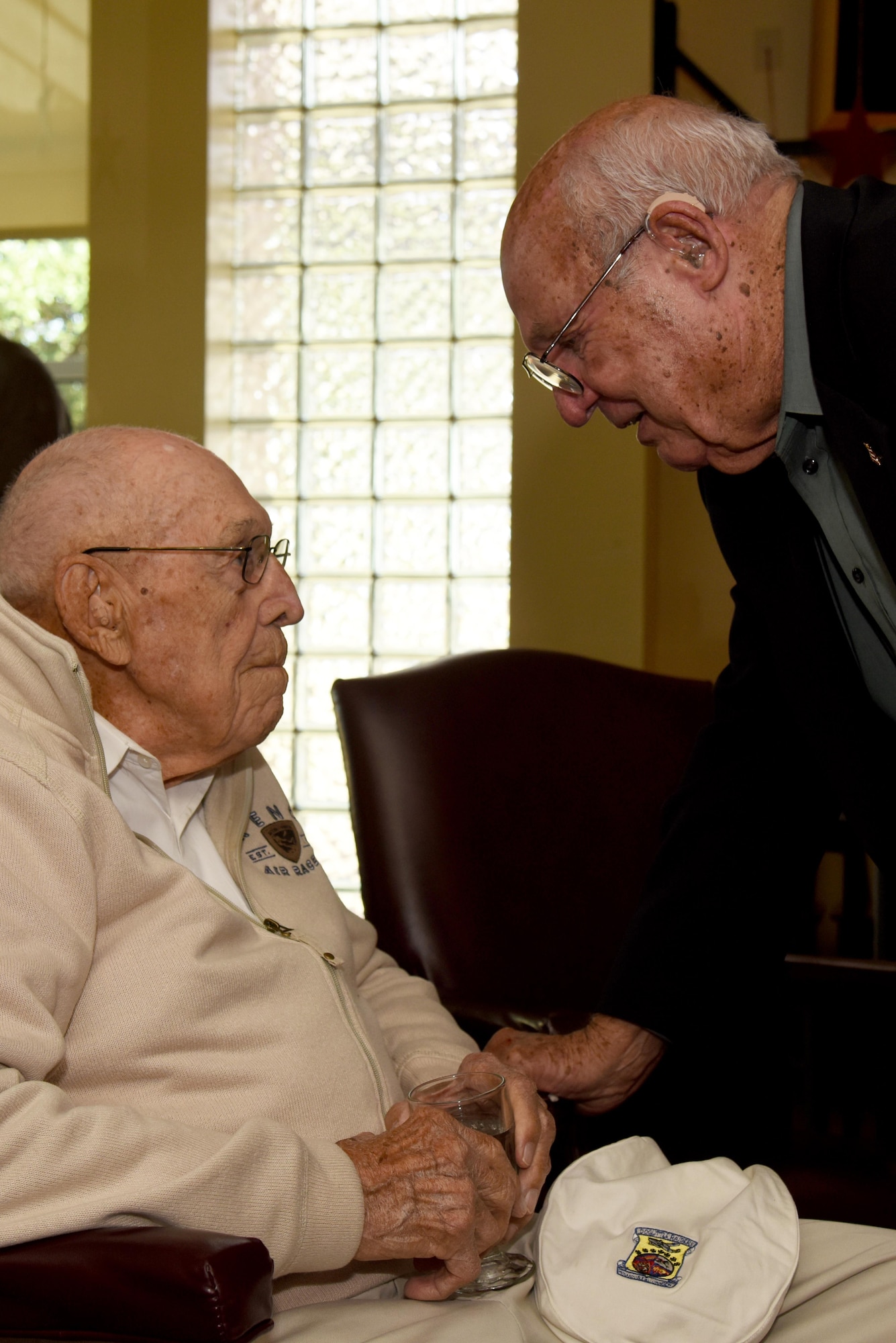 Retired U.S. Air Force Col. Charlie Powell, former 17th Training Wing Commander, meets retired U.S. Army Air Corps Lt. Col. Richard E. Cole, Doolittle Raider, at the Event Center on Goodfellow Air Force Base, Texas, Nov. 12, 2015. Cole came to Goodfellow to provide a Q-and-A session and sign autographs. (U.S. Air Force photo by Senior Airman Joshua Edwards/Released)