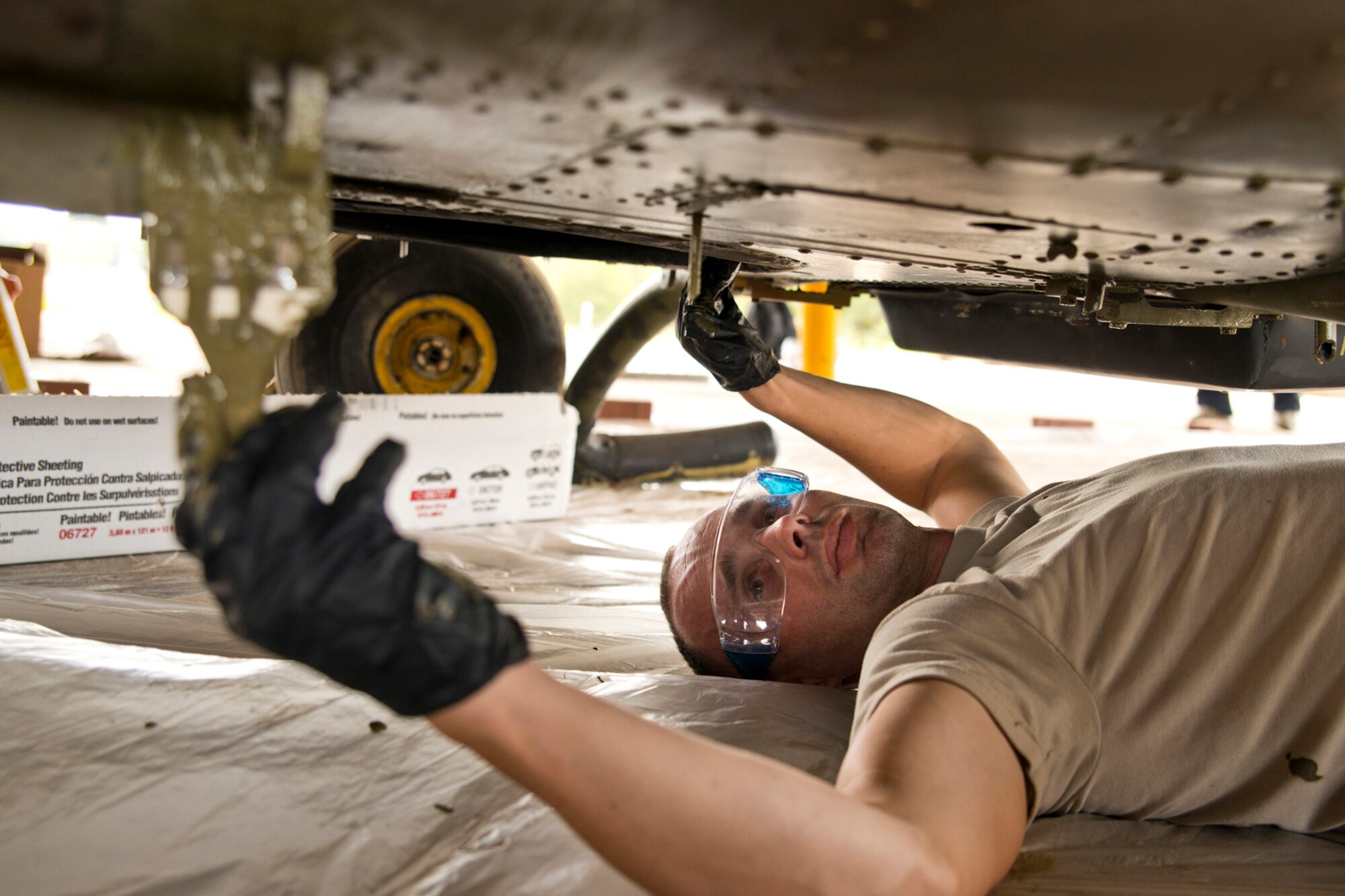 U.S. Air Force Master Sgt. Michael Jester, fabrication flight chief, 913th Maintenance Squadron, Little Rock Air Force Base, Ark., paints the underside of a Bell UH-1C Iroquois helicopter at the city’s recycling center just outside the Air Force base in Jacksonville, Ark., Oct. 9, 2015. Jester was one of many Airmen who helped restore the Vietnam era chopper for the Jacksonville Museum of Military History. (U.S. Air Force photo by Master Sgt. Jeff Walston/Released) 