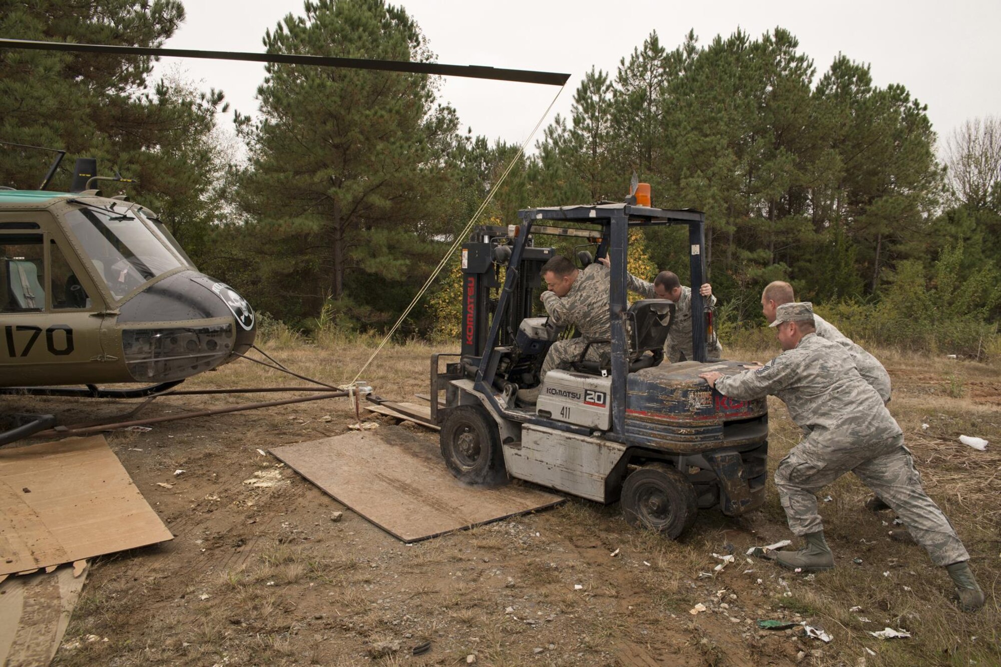 U.S. Air Force Airmen assigned to 913th Maintenance Squadron at Little Rock Air Force Base, Ark., attempt to get a forklift out of the mud at the city recycling center in Jacksonville, Ark., Nov. 3, 2015. The Airmen were moving a newly restored Vietnam era Bell UH-1C Iroquois helicopter to a staging area so it could be returned to the Jacksonville Museum of Military History the next day. (U.S. Air Force photo by Master Sgt. Jeff Walston/Released)