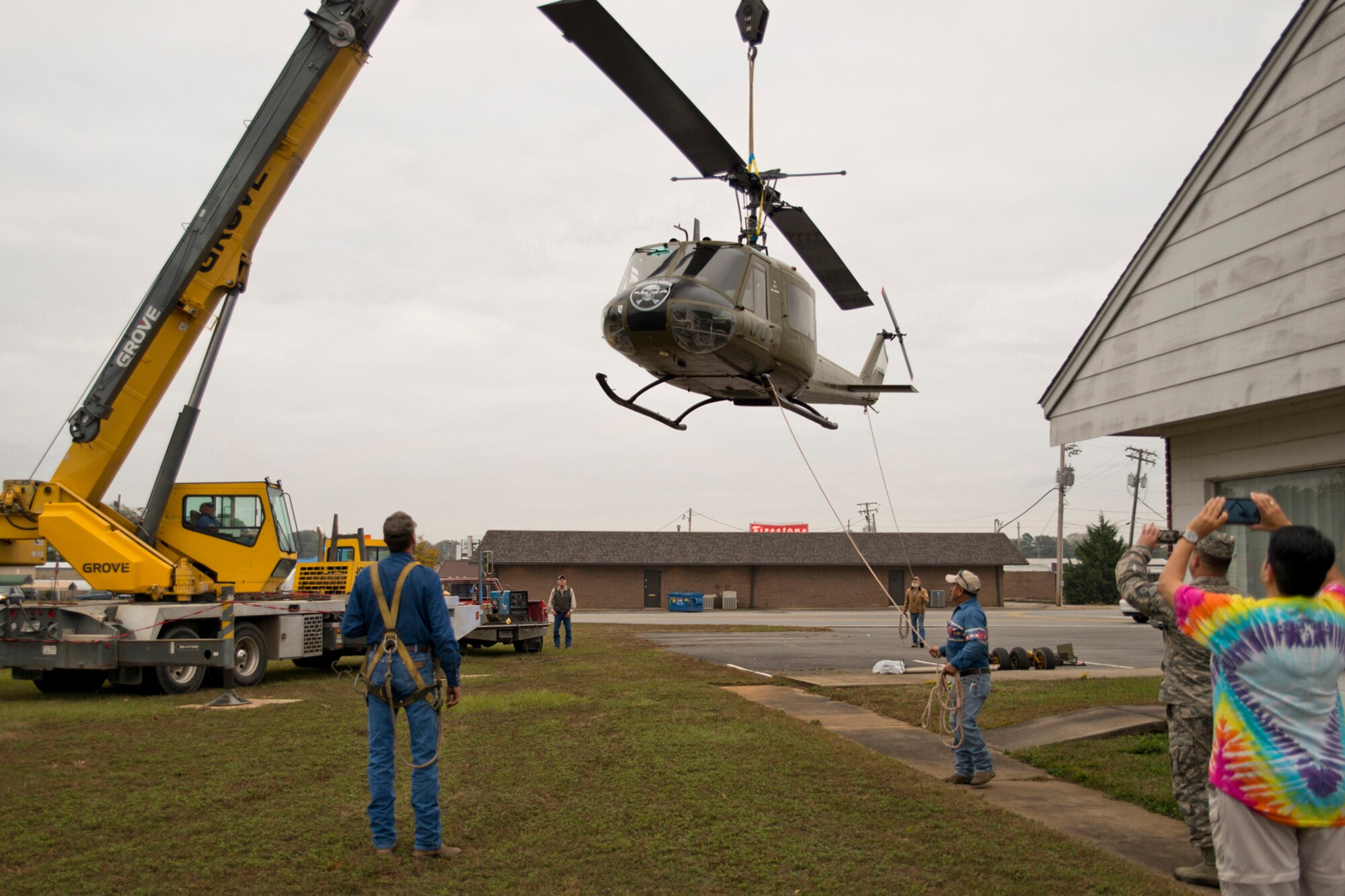Dannakay Duggar, museum director, Jacksonville Museum of Military History and Senior Master Sgt. Harry Watson, an aircraft electrician supervisor assigned to the 913th Maintenance Squadron, record the placement of a newly restored Bell UH-1C Iroquois helicopter back on its display pedestal in Jacksonville, Ark., Nov. 4, 2015. The return of the Vietnam era helicopter to the museum marks the end of a restoration project that started in June 2015. Both military and civilian communities came together to restore the aircraft for future generations to see at the museum. (U.S. Air Force photo by Master Sgt. Jeff Walston/Released)