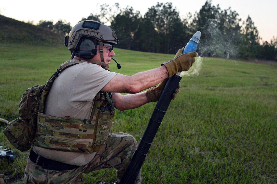 An Army Green Beret loads a round into a hot mortar system before firing it at training targets during Southern Strike 16 on Camp Shelby Joint Forces Training Center, Miss., Nov. 4, 2015. New York Air National Guard photo by Staff Sgt. Christopher S. Muncy
