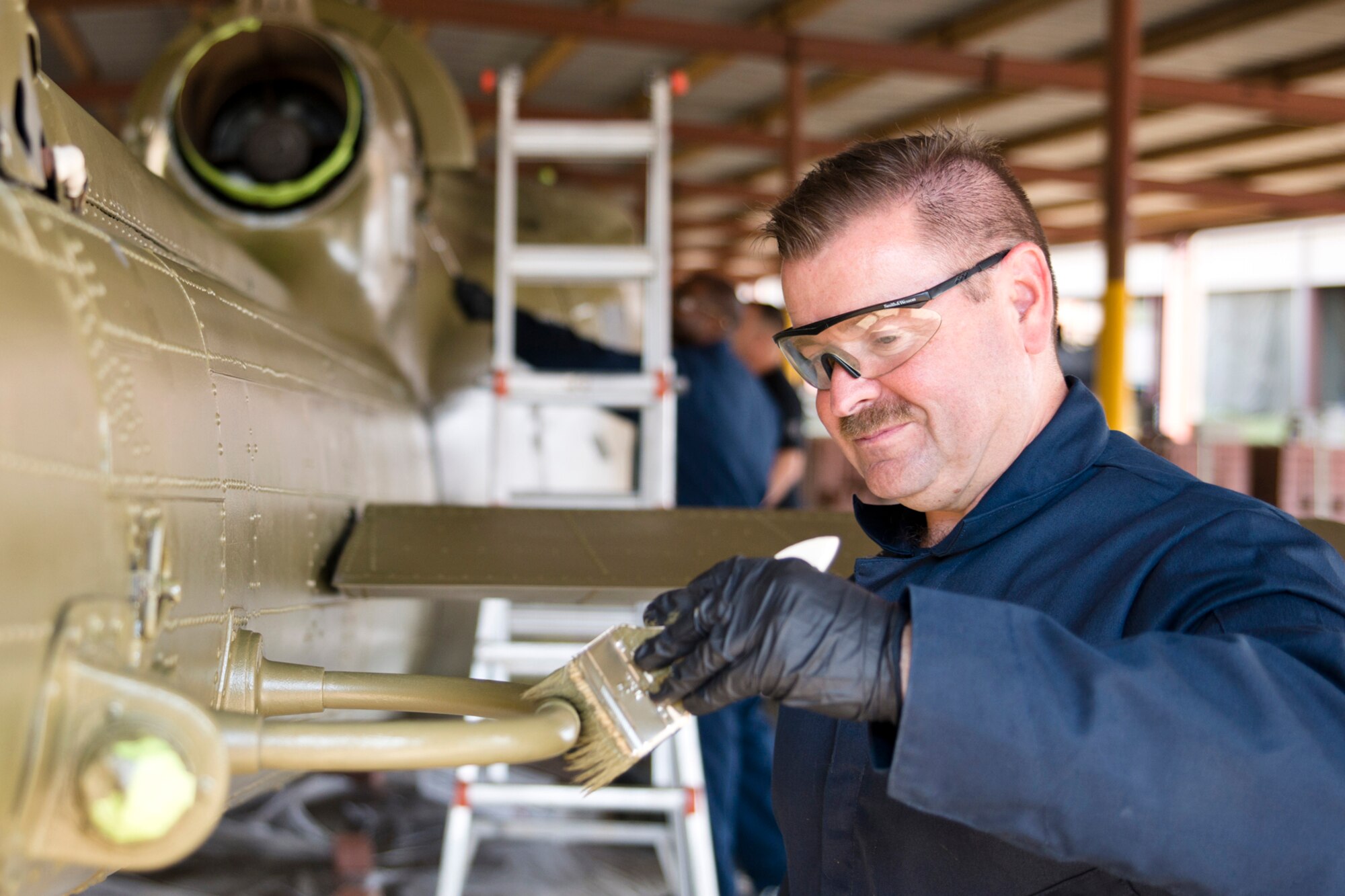 U.S. Air Force Senior Master Sgt. Harry Watson, aircraft electrician supervisor, 913th Maintenance Squadron, Little Rock Air Force Base, Ark., helps paints a Bell UH-1C Iroquois helicopter at the city’s recycling center in Jacksonville, Ark., Oct. 9, 2015. Watson was one of many Airmen who helped restore the Vietnam era chopper that was returned to the Jacksonville Museum of Military History for display Nov. 4, 2015. (U.S. Air Force photo by Master Sgt. Jeff Walston/Released) 