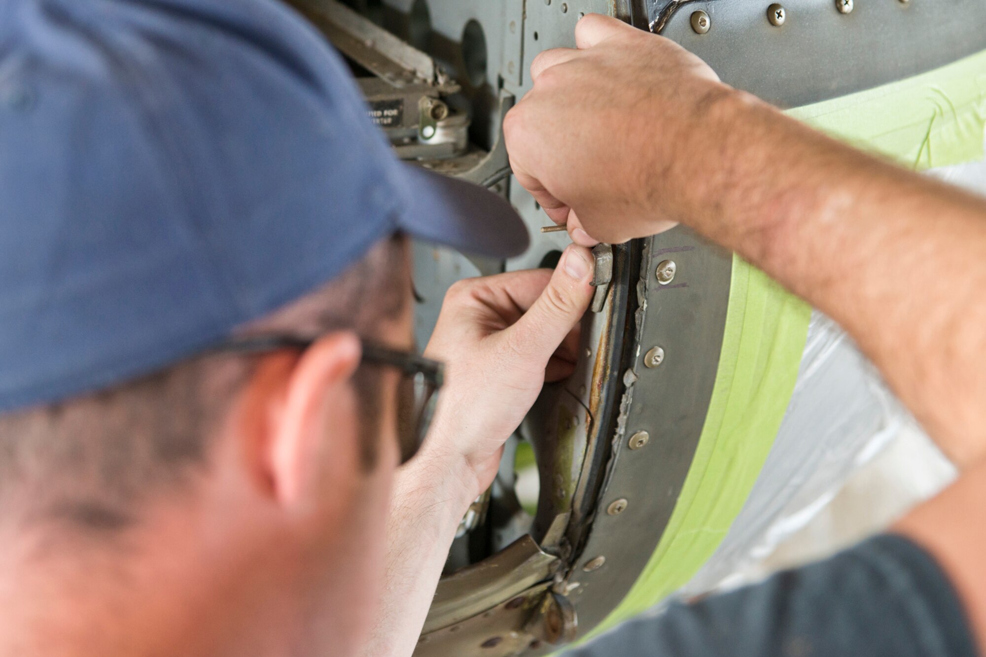 U.S. Air Force Staff Sgt. Brandon Thelen, sheet metal craftsman, 913th Maintenance Squadron, relocates brackets for hood latches on a Bell UH-1C Iroquois helicopter at the city’s recycling center just outside the Little Rock Air Force base in Jacksonville, Ark., Oct. 9, 2015. Thelen was one of a group of Airmen that helped restore a Vietnam era chopper that was returned to the Jacksonville Museum of Military History for display Nov. 4, 2015. (U.S. Air Force photo by Master Sgt. Jeff Walston/Released) 