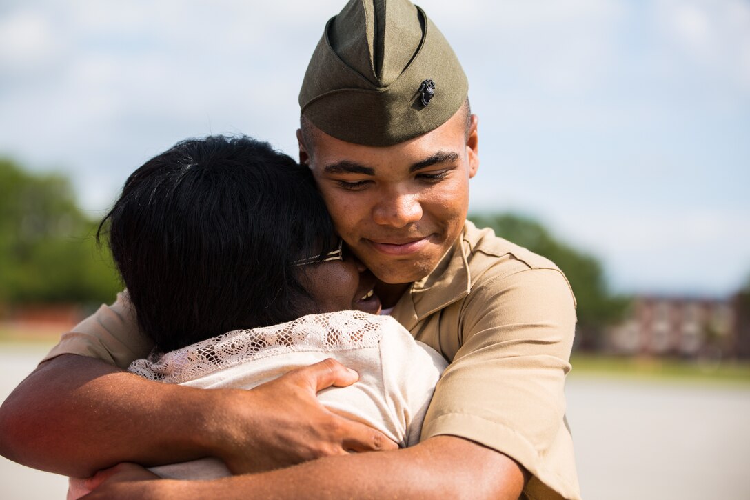 A new Marine of Fox Company, 2nd Recruit Training Battalion, greets his family following his graduation ceremony June 5, 2015, on Parris Island, S.C. The Marines spent nearly 13 weeks away from home training to earn their places in the Corps. (Photo by Sgt. Jennifer Schubert)