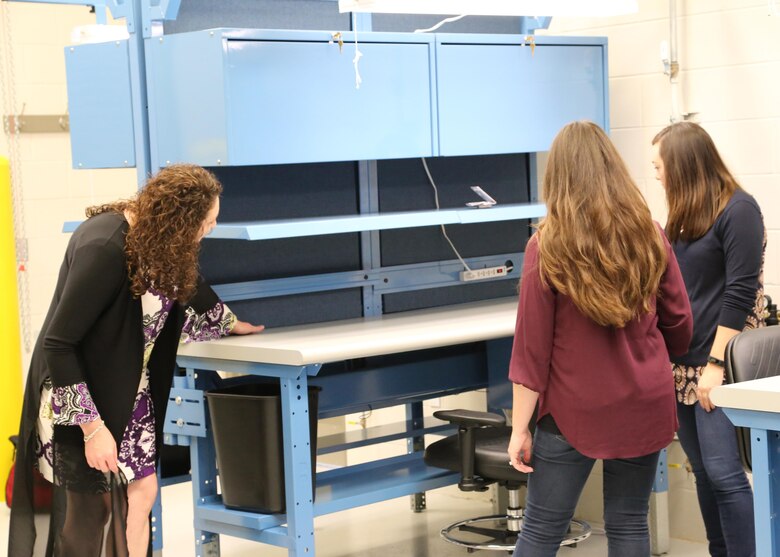 Left, Leslie Yarbrough, program manager; Sara Cook, project manager, and Elizabeth Stiles, interior designer, U.S. Army Engineering and Support Center Huntsville Furnishings Program, complete a quality assurance inspection on equipment purchased as part of a $385,000 project within the Gray Eagle Unmanned Aerial System (UAS) cantonment area that included a company operations facility, tactical equipment maintenance facility, operations and storage facility, and control tower.
