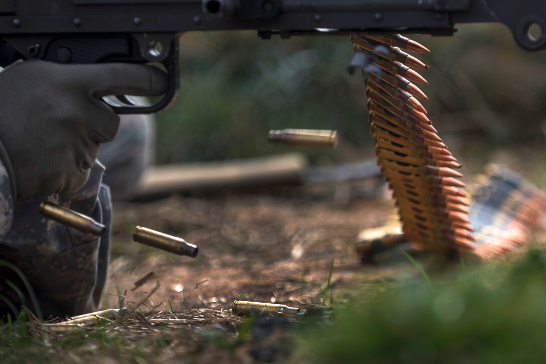 Brass 7.62 mm shells eject from an M240B machine gun during a qualification range event on Camp Atterbury, Ind., Nov. 6, 2015. U.S. Army photo by Master Sgt. Michel Sauret